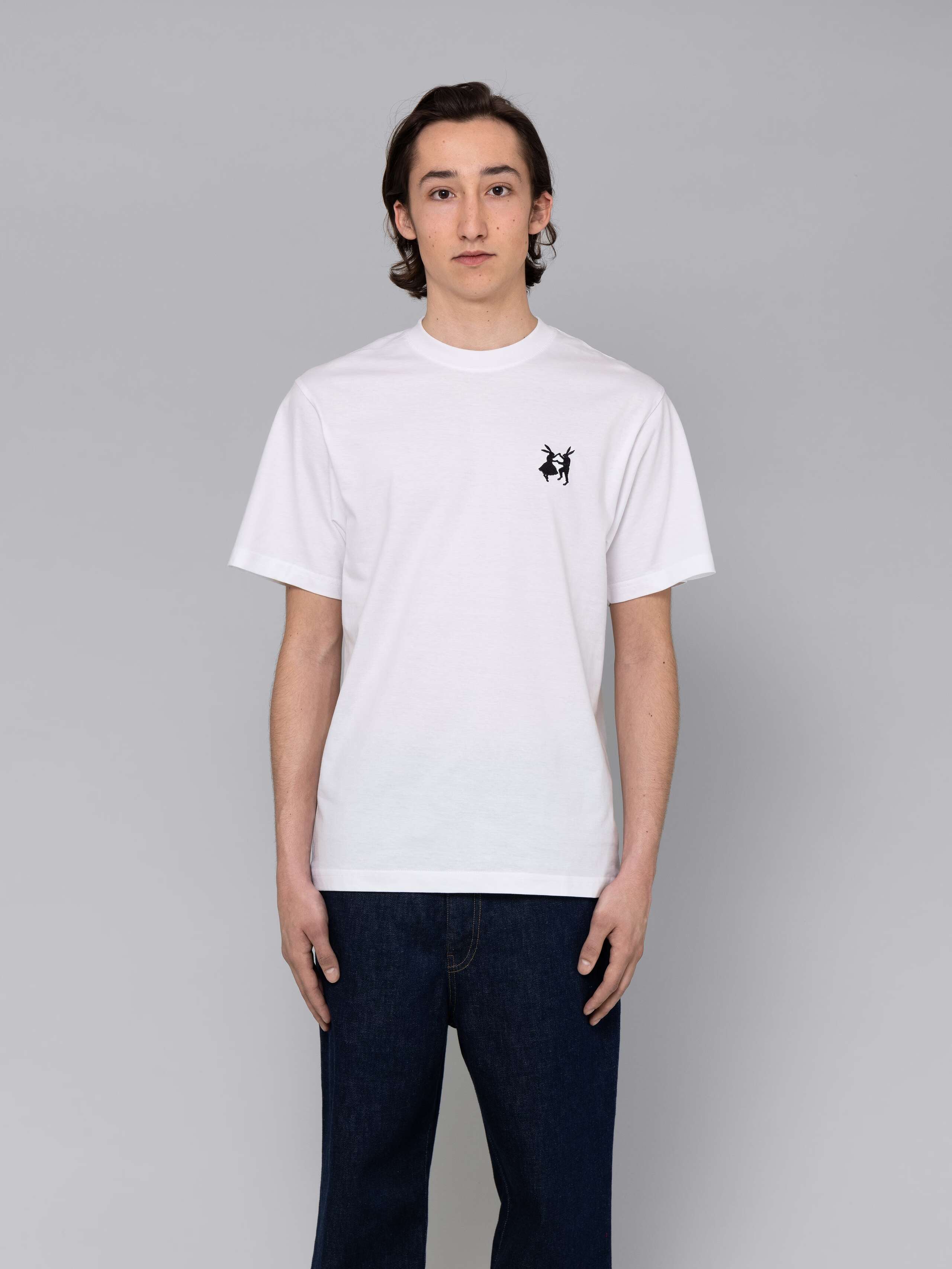 Male model is wearing a combination of a classic jeans and a white t-shirt