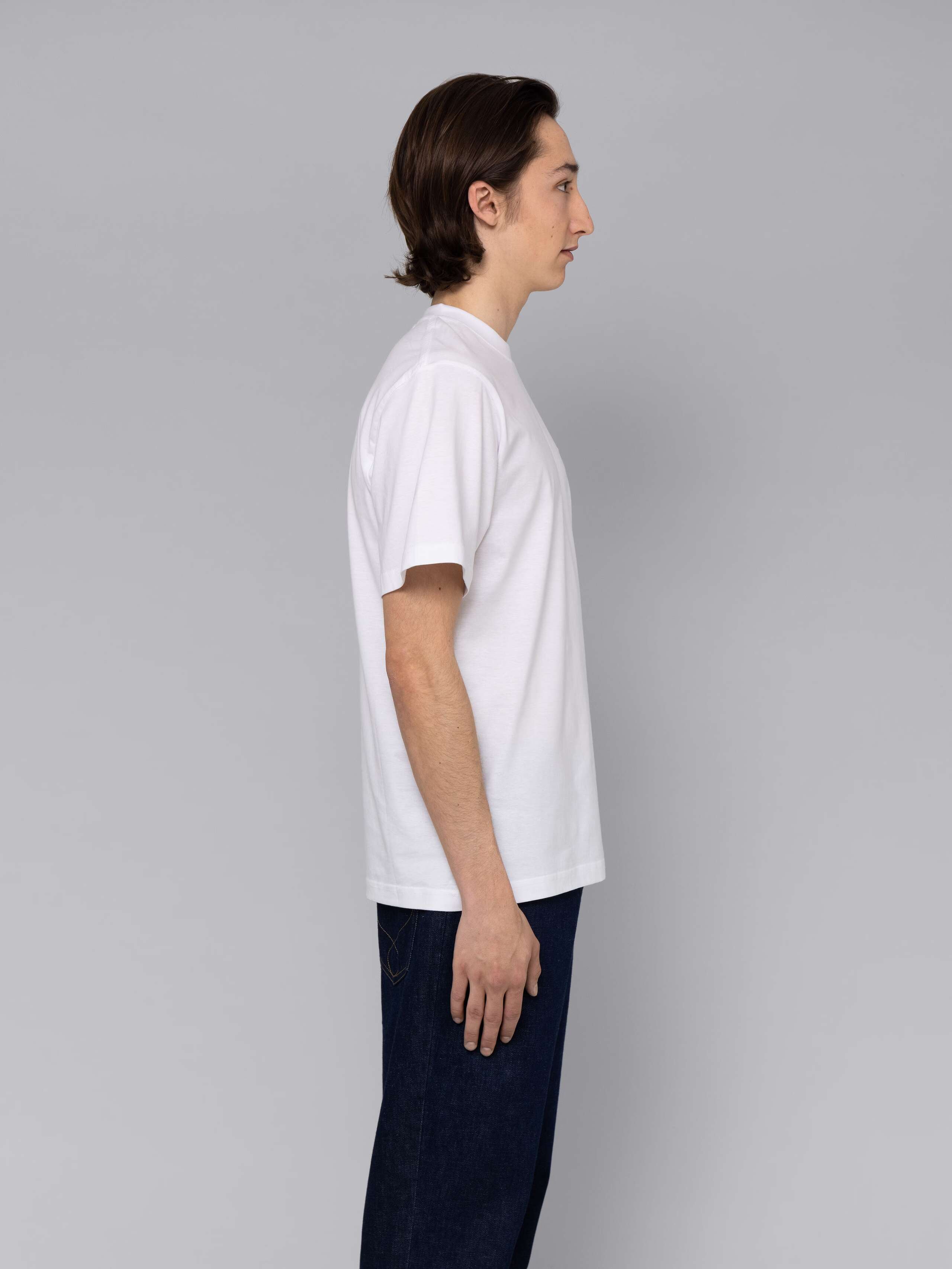 Male model is wearing a combination of a classic jeans and a white t-shirt