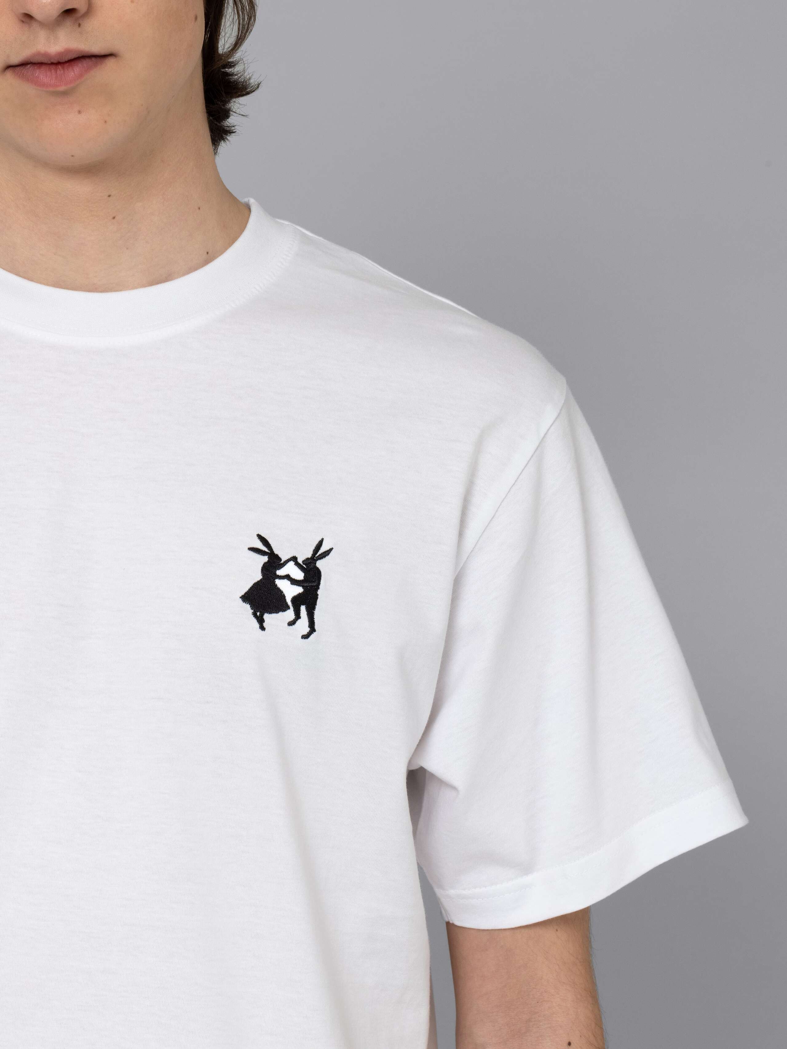 Male model is wearing a white t-shirt with a black rabbit embroidery