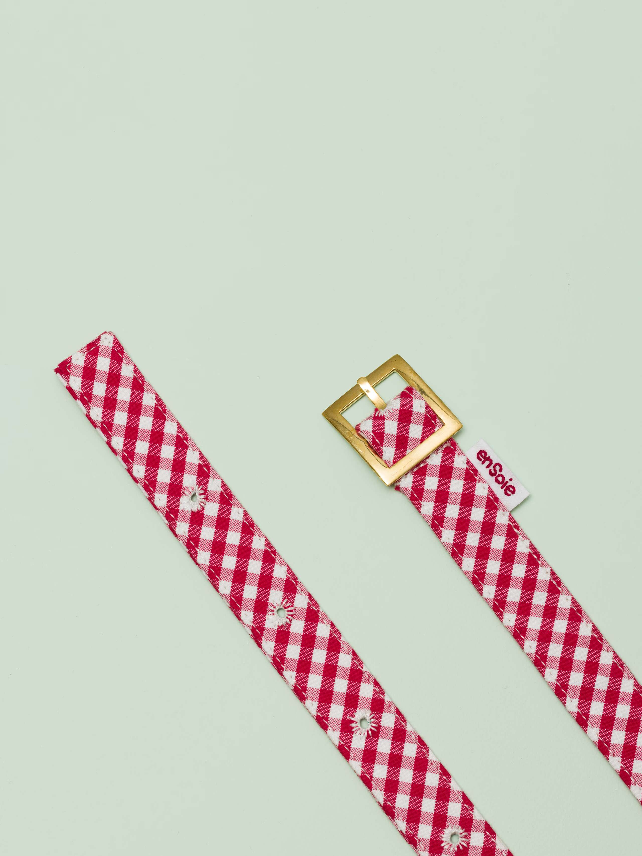 Picture of a belt made of cotton featuring a red vichy check pattern