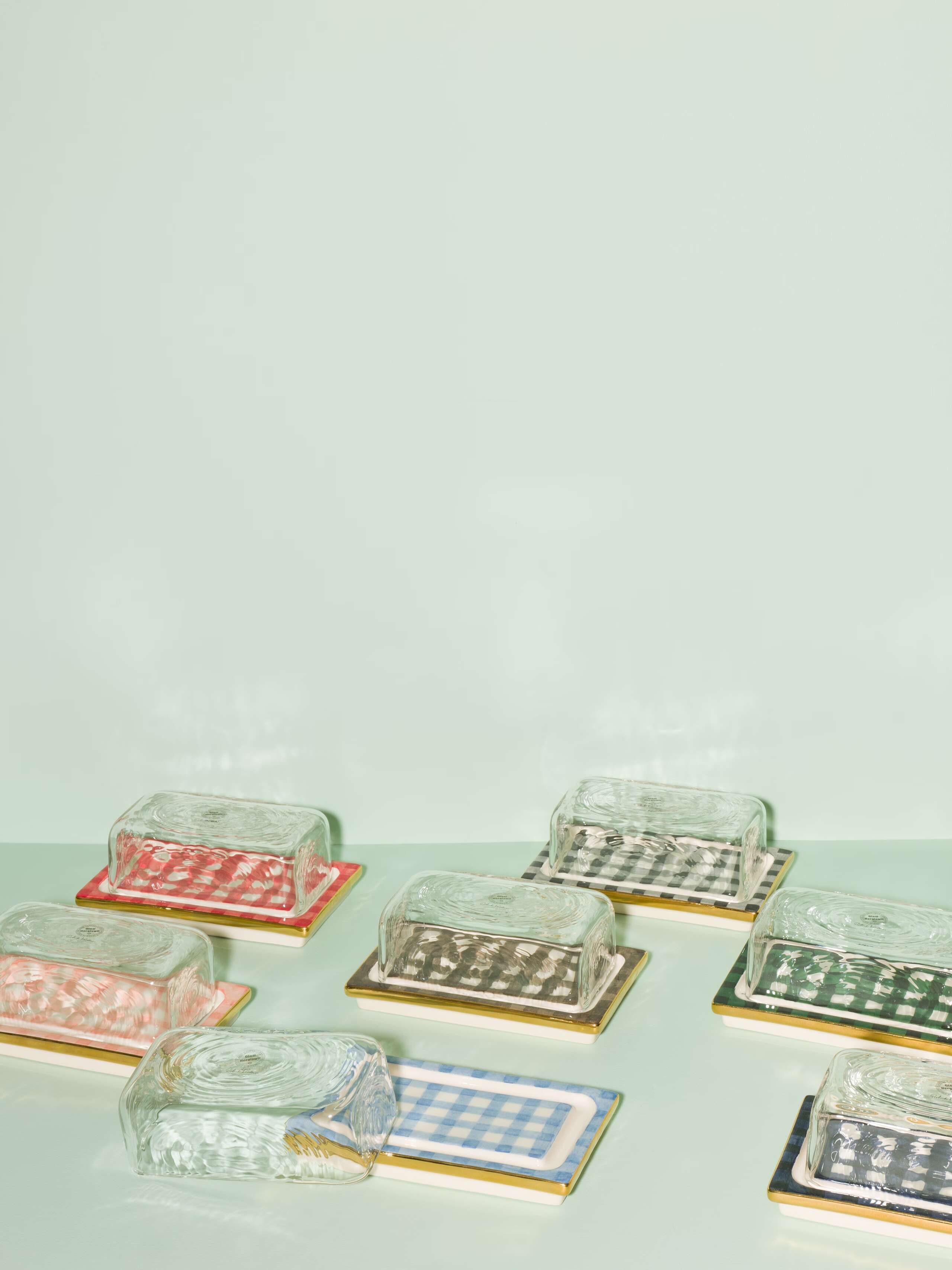 Picture of seven beautiful handmade ceramic butter plates with a glass top