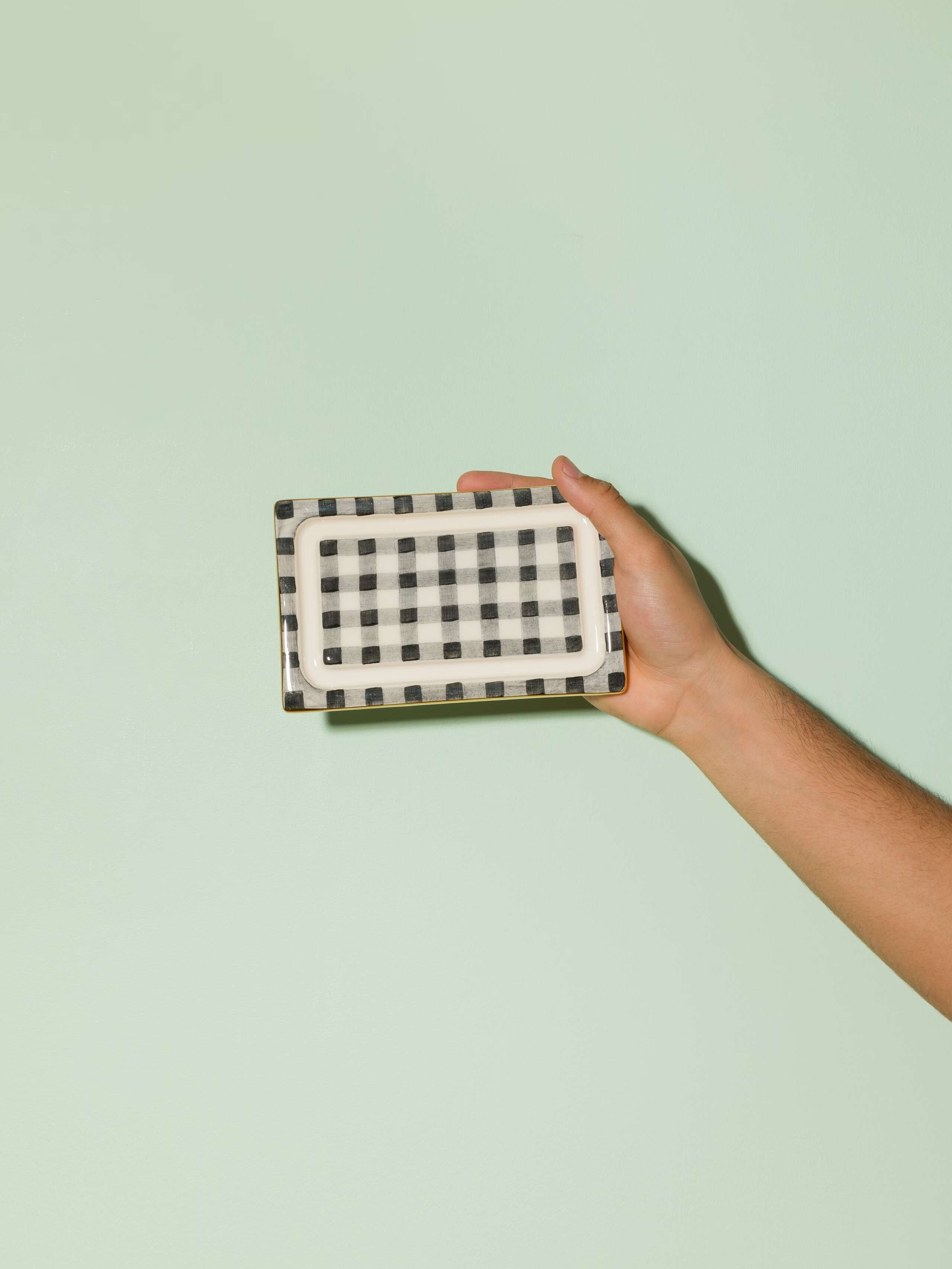Picture of a beautiful handmade ceramic butter plate featuring a black vichy check pattern