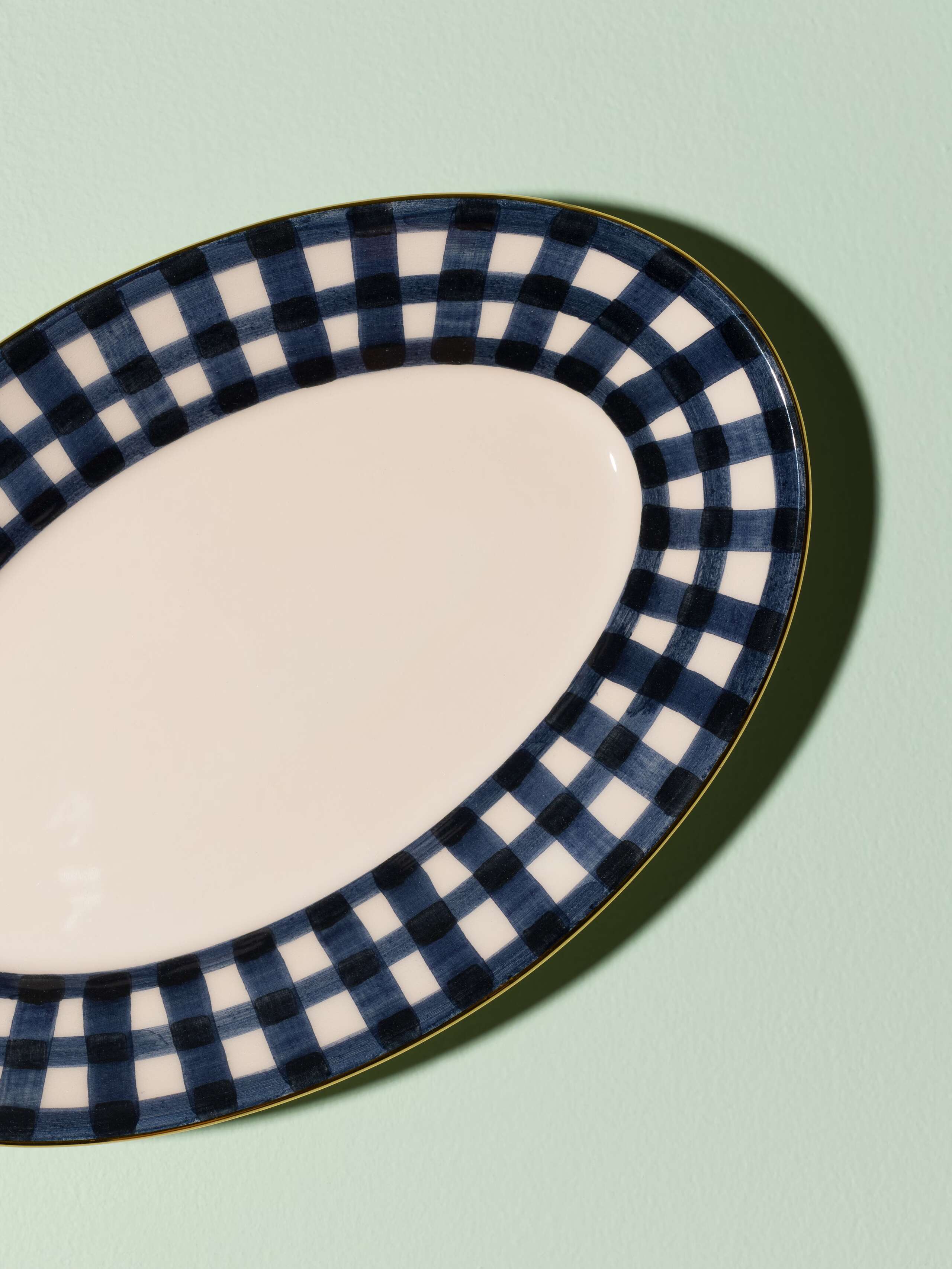 Picture of a beautiful handmade tapas plate featuring a classic navy blue vichy check pattern