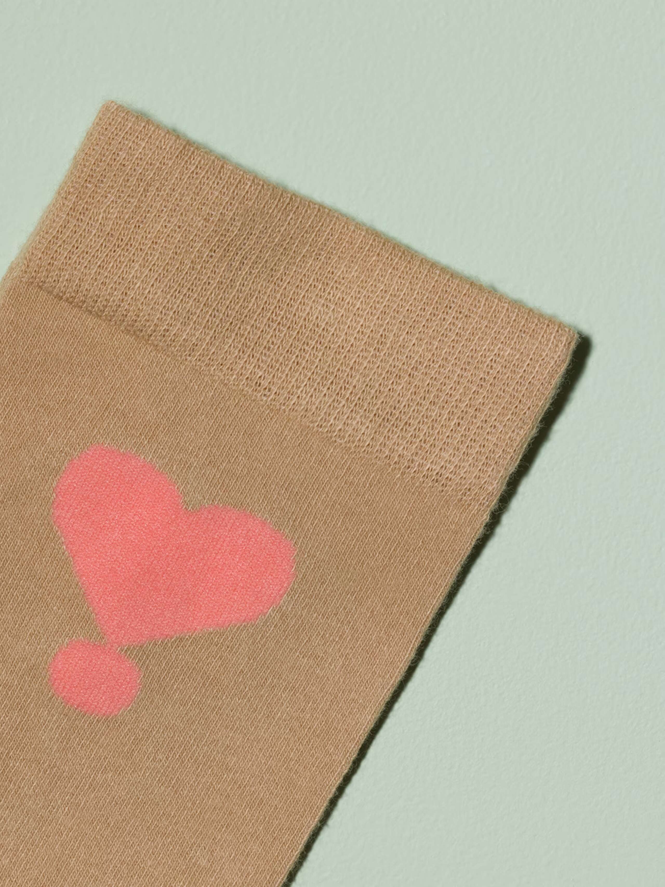 Picture of a beige sock with pink heart