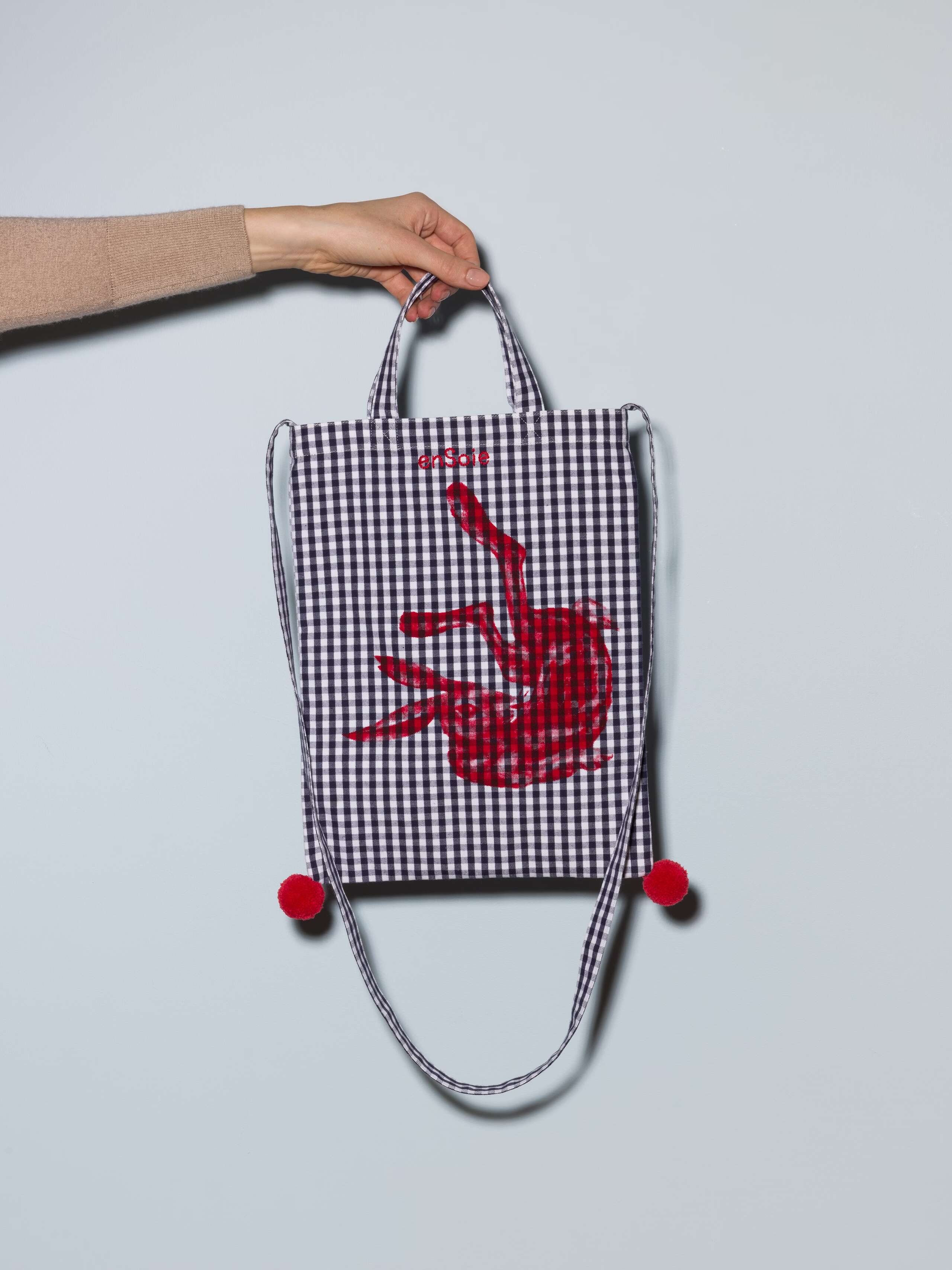 Picture of a small tote bag featuring a beautiful navy vichy check pattern and a red screen printed rabbit
