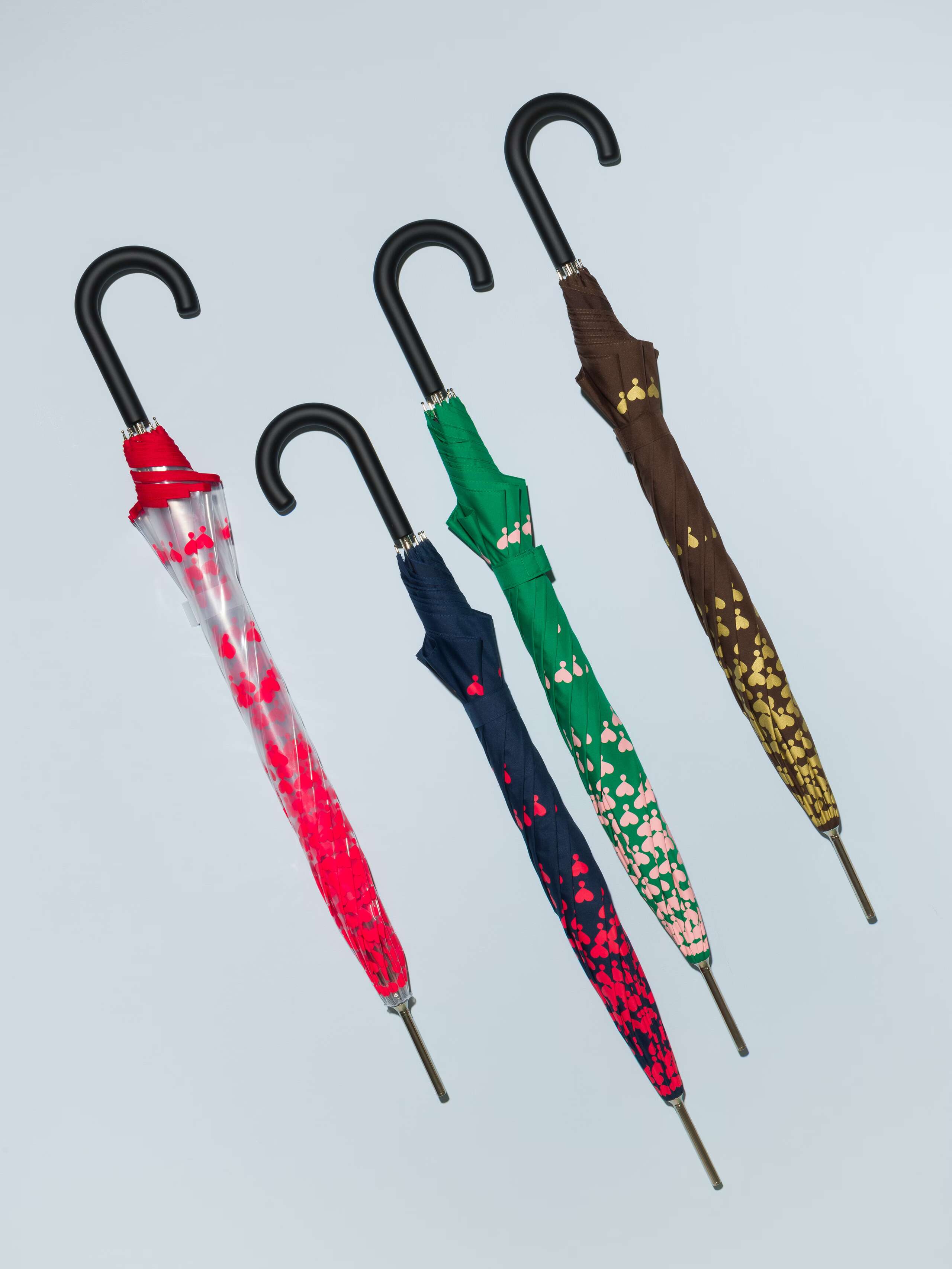 Picture of four coulourful umbrellas featuring a cute heart print