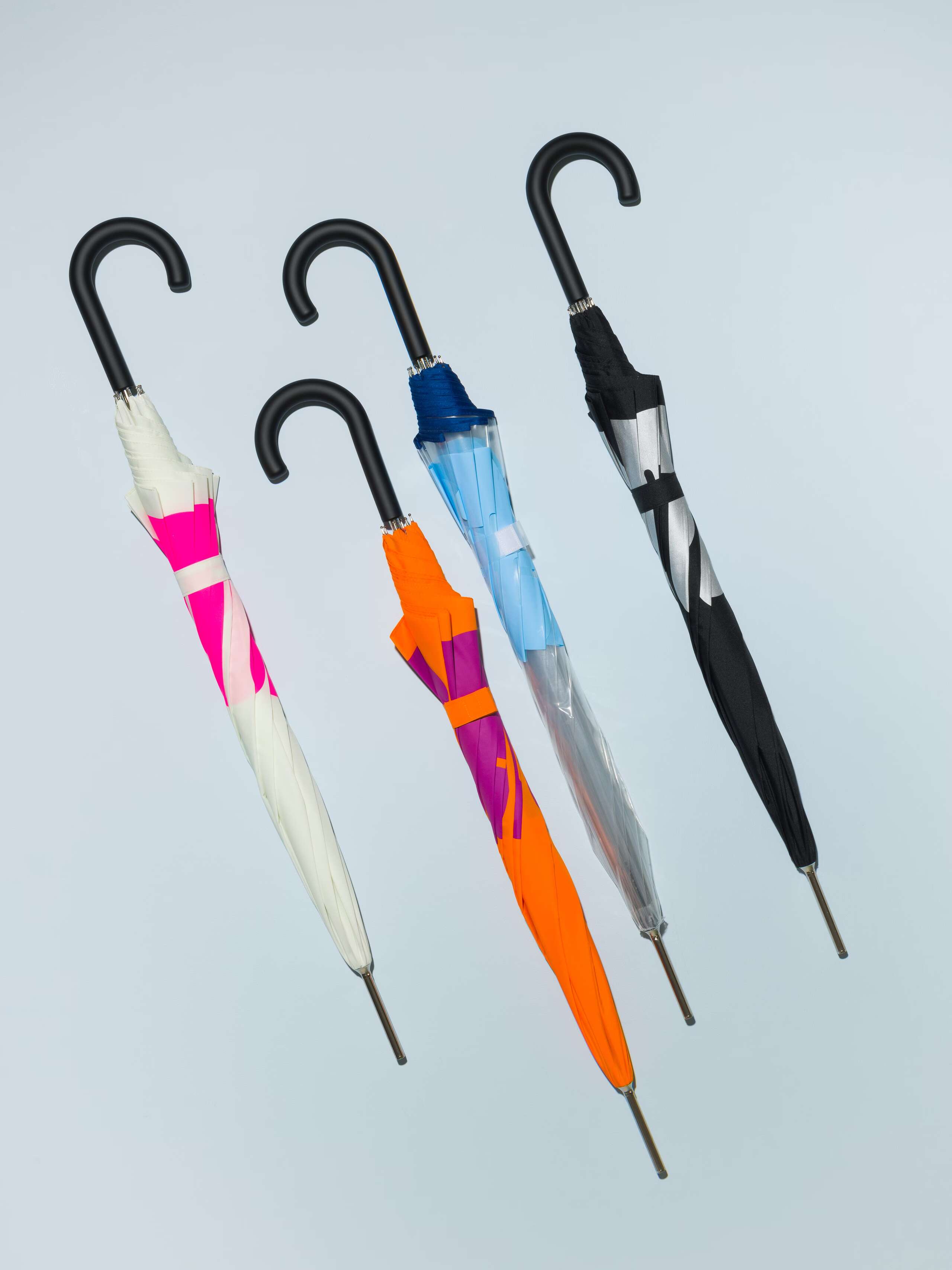 Picture of four coulourful umbrellas featuring the motto "love rules forever"