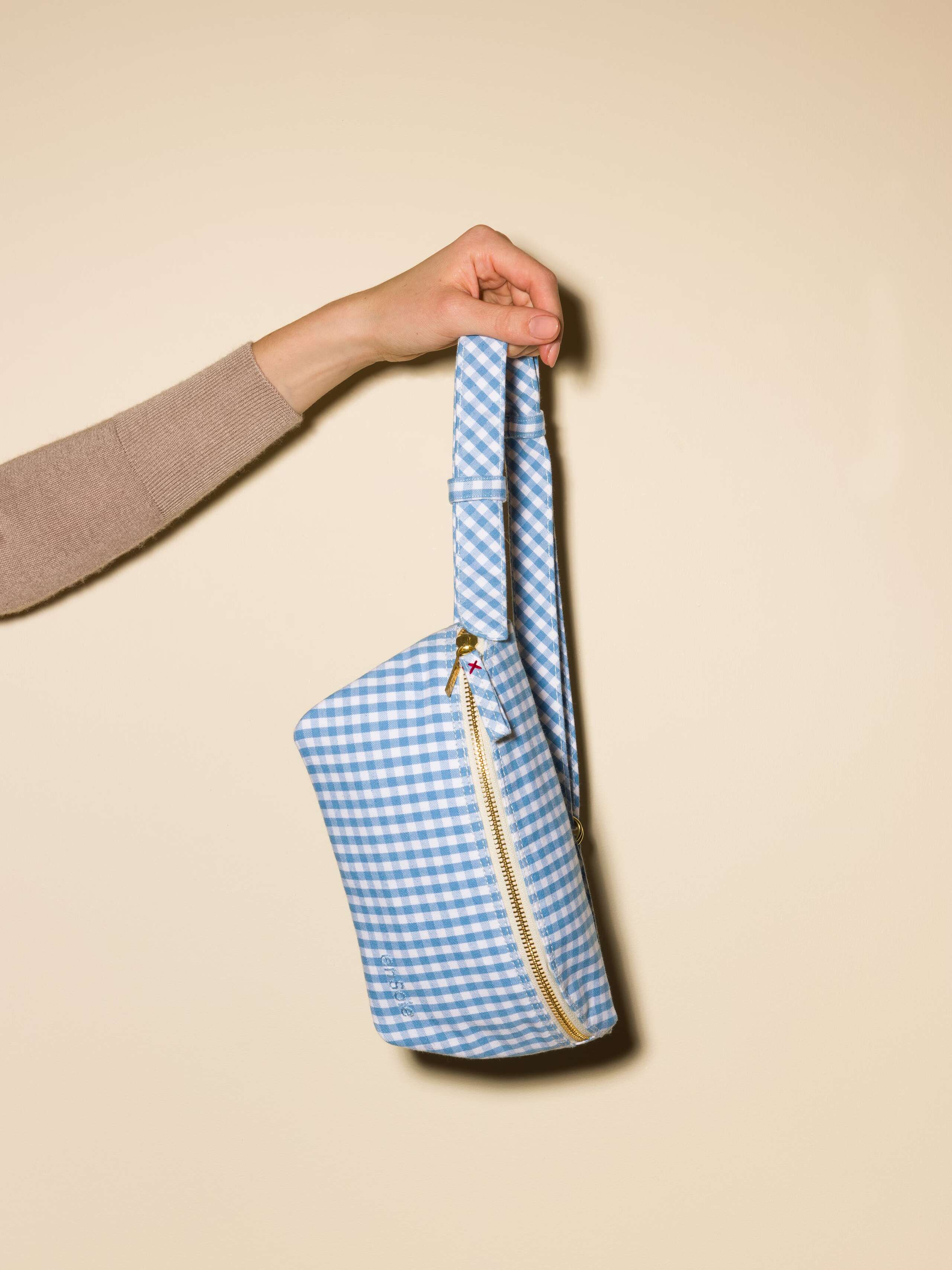 Picture of a hip bag featuring a light blue vichy check pattern