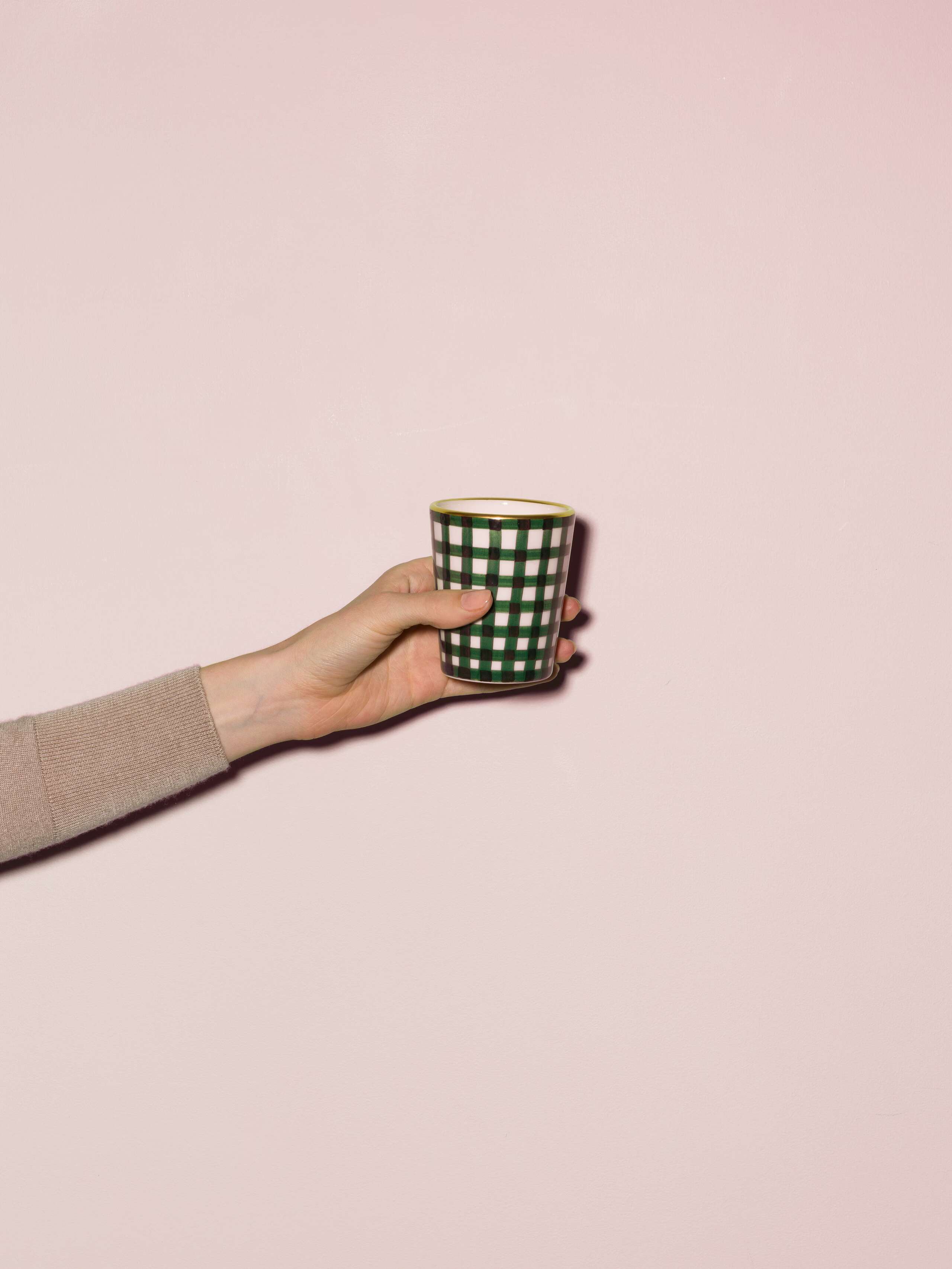 Picture of a handmade and handprinted cup made of ceramic featuring a green vichy check pattern