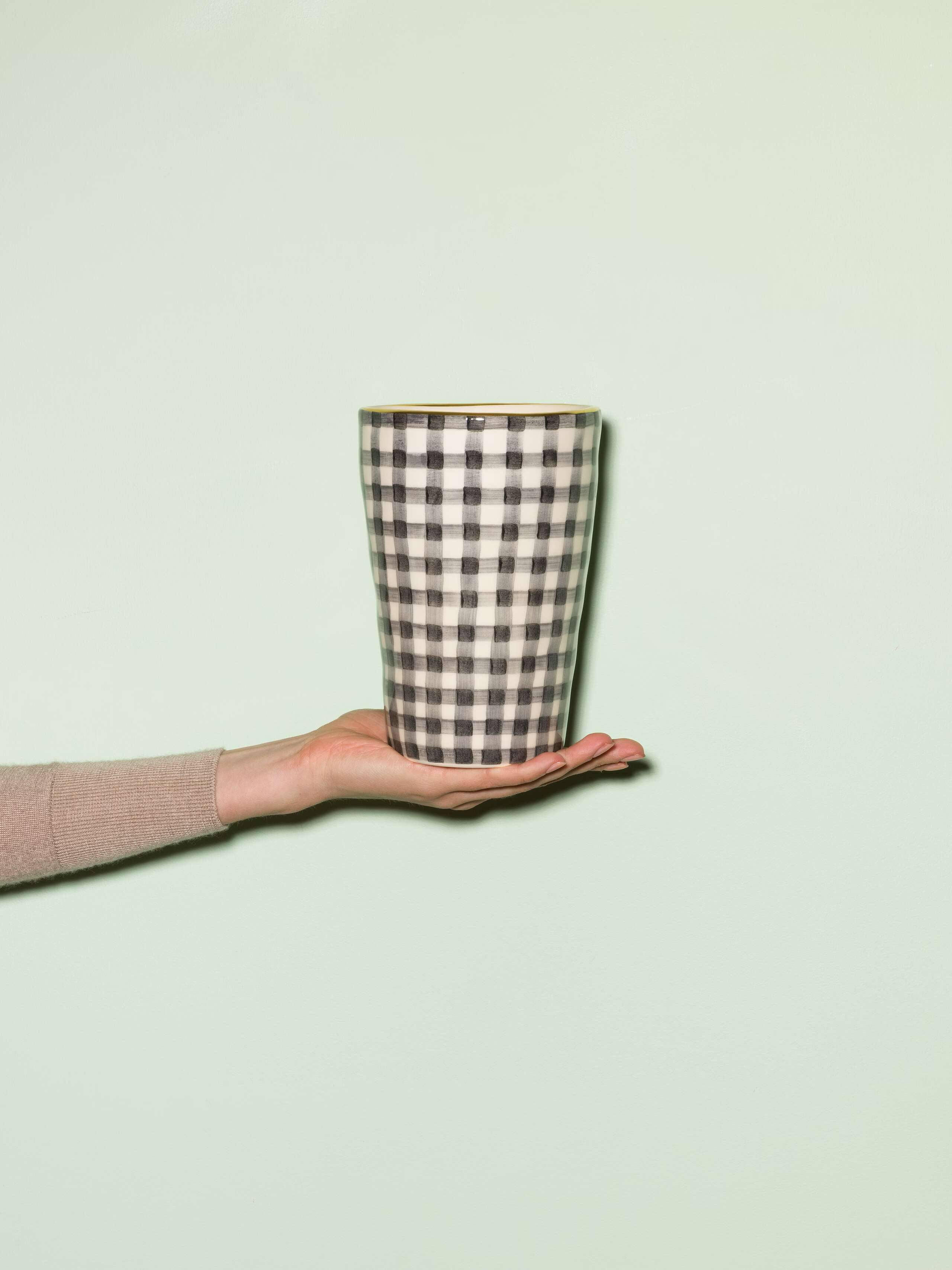 Picture of a handmade and handprinted vase made of ceramic featuring a black vichy check pattern