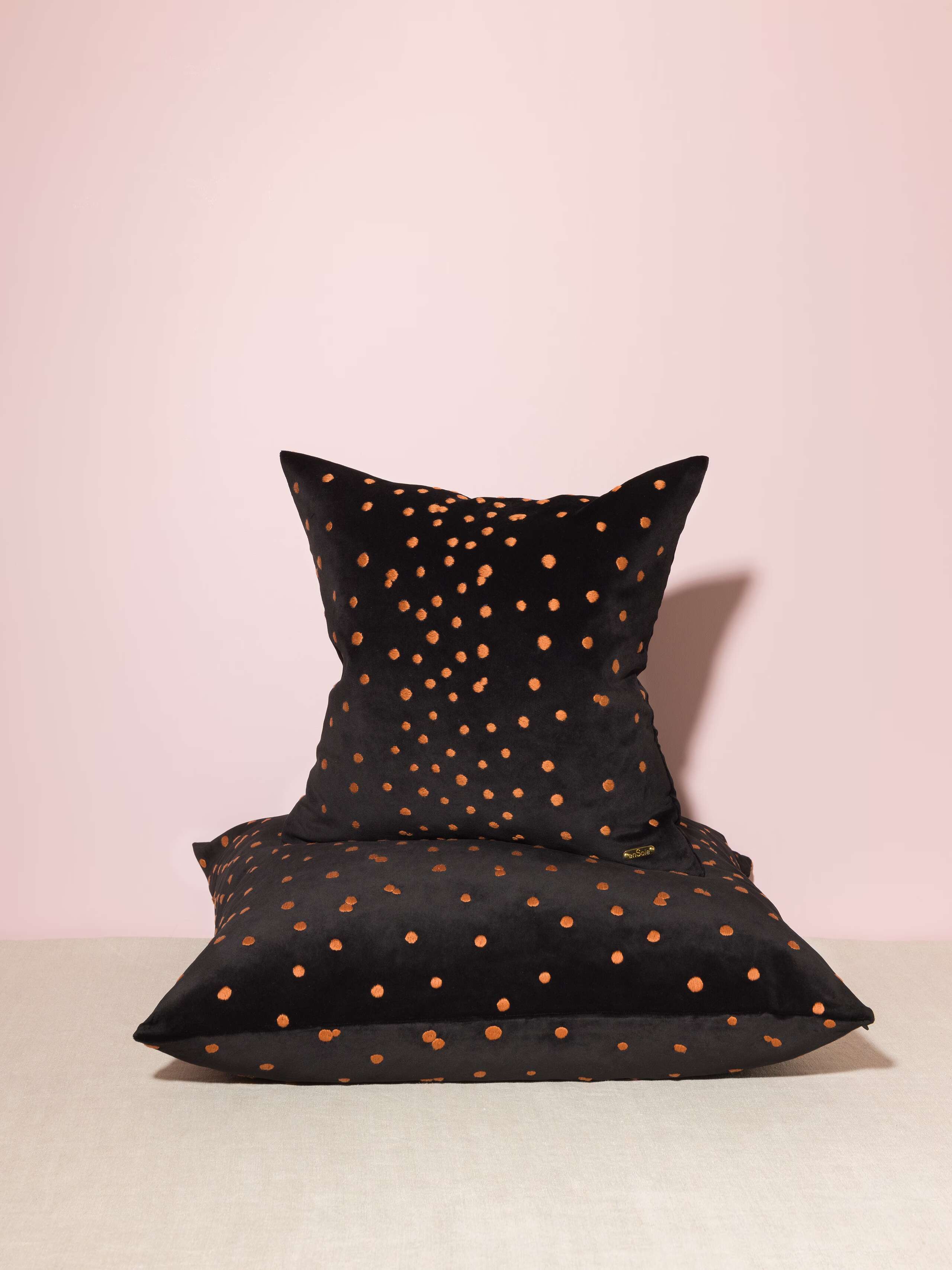 Picture of two pillow covers made of black cotton velvet fabric with brown embroidery