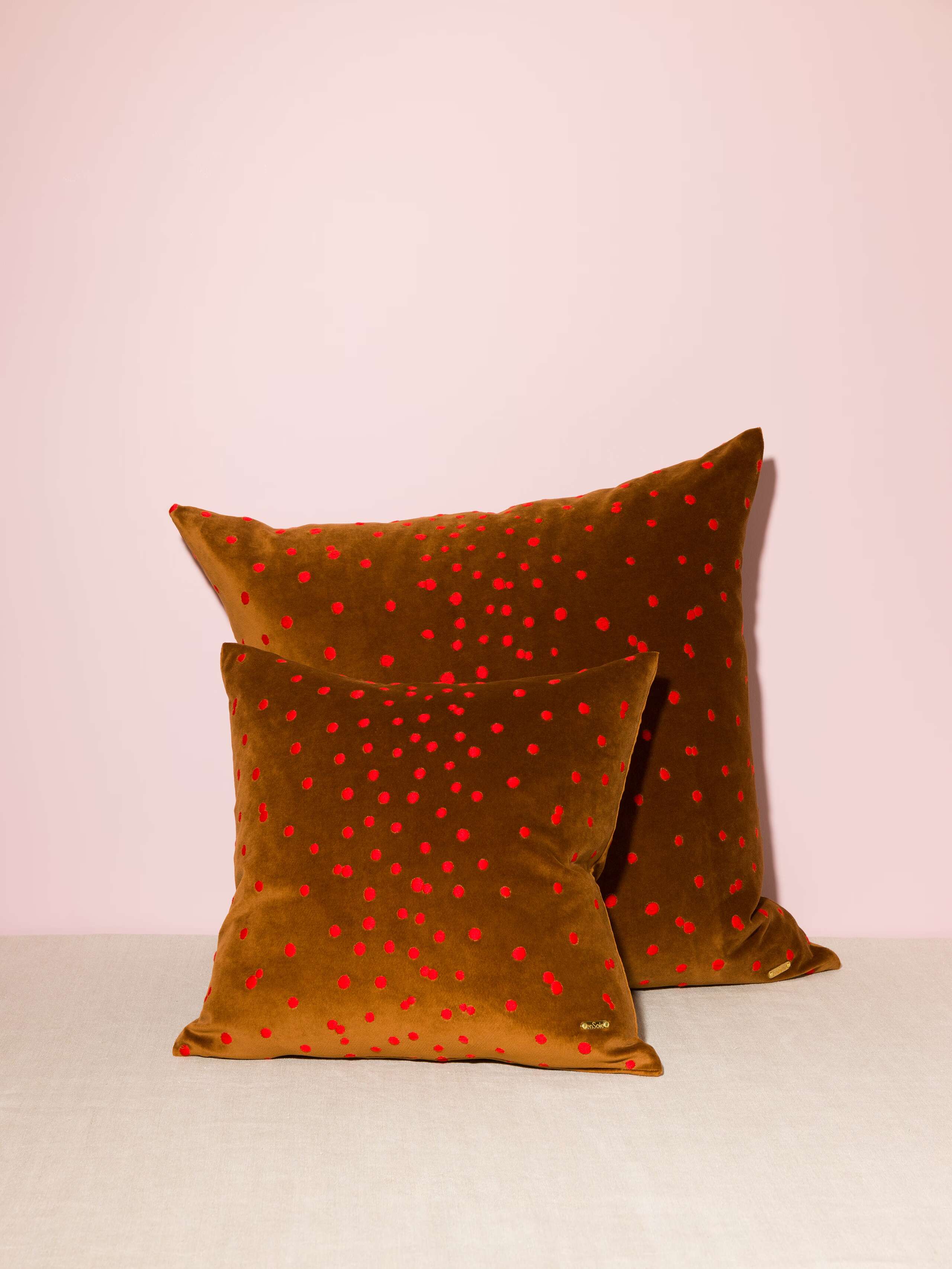 Picture of two pillow covers made of redbrown cotton velvet fabric with red embroidery