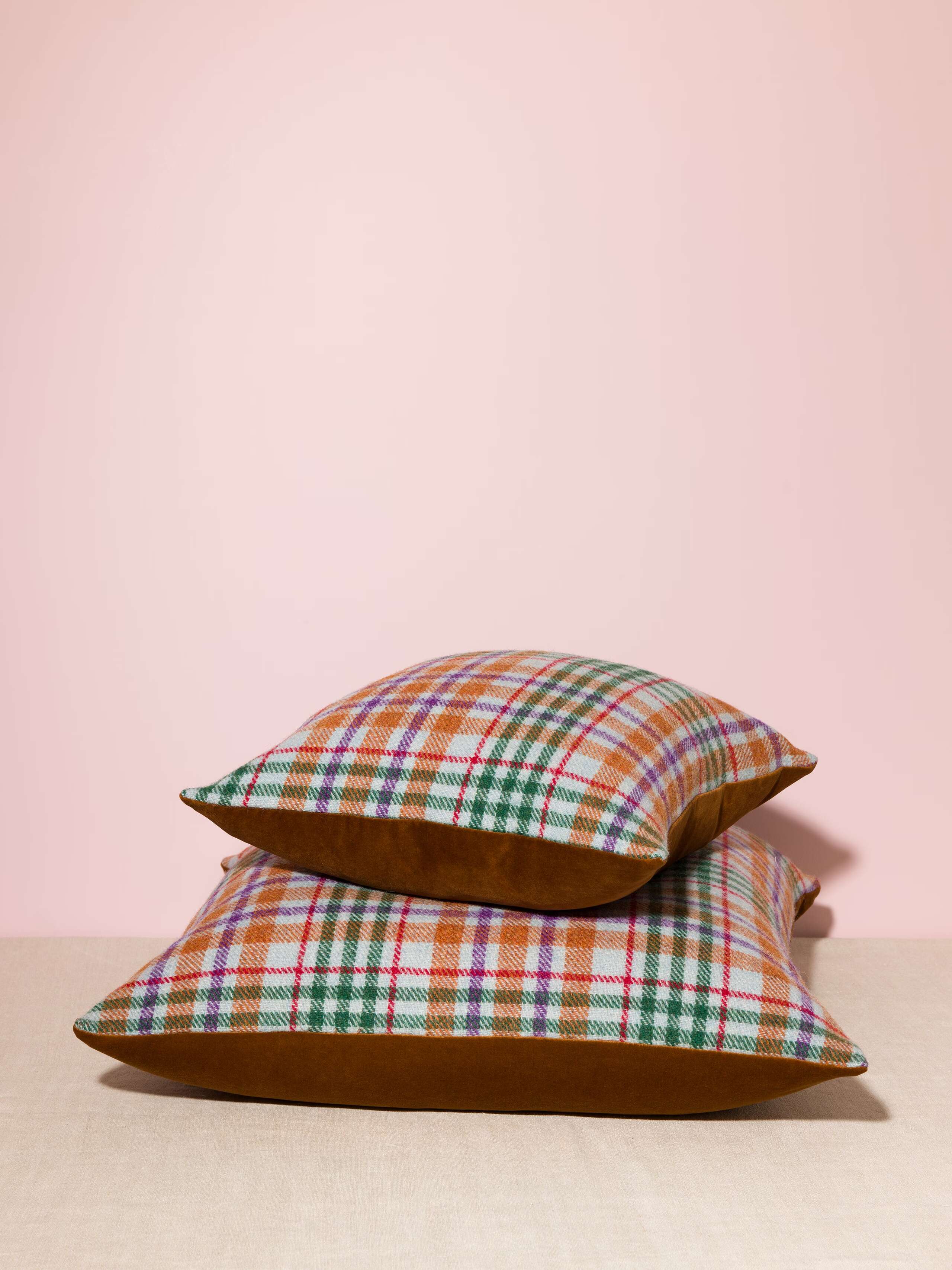 Picture of a pillow cover made of brown cotton velvet and colourful harris tweed in green, light blue, orange and lilac shaeds