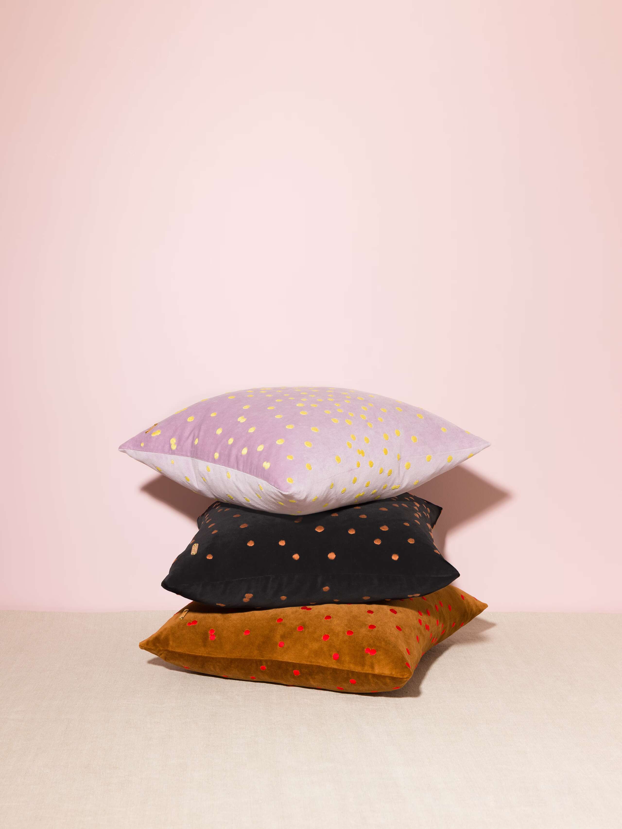 Picture of three beautiful pillow covers made of warm brown, light lilac and black cotton velvet