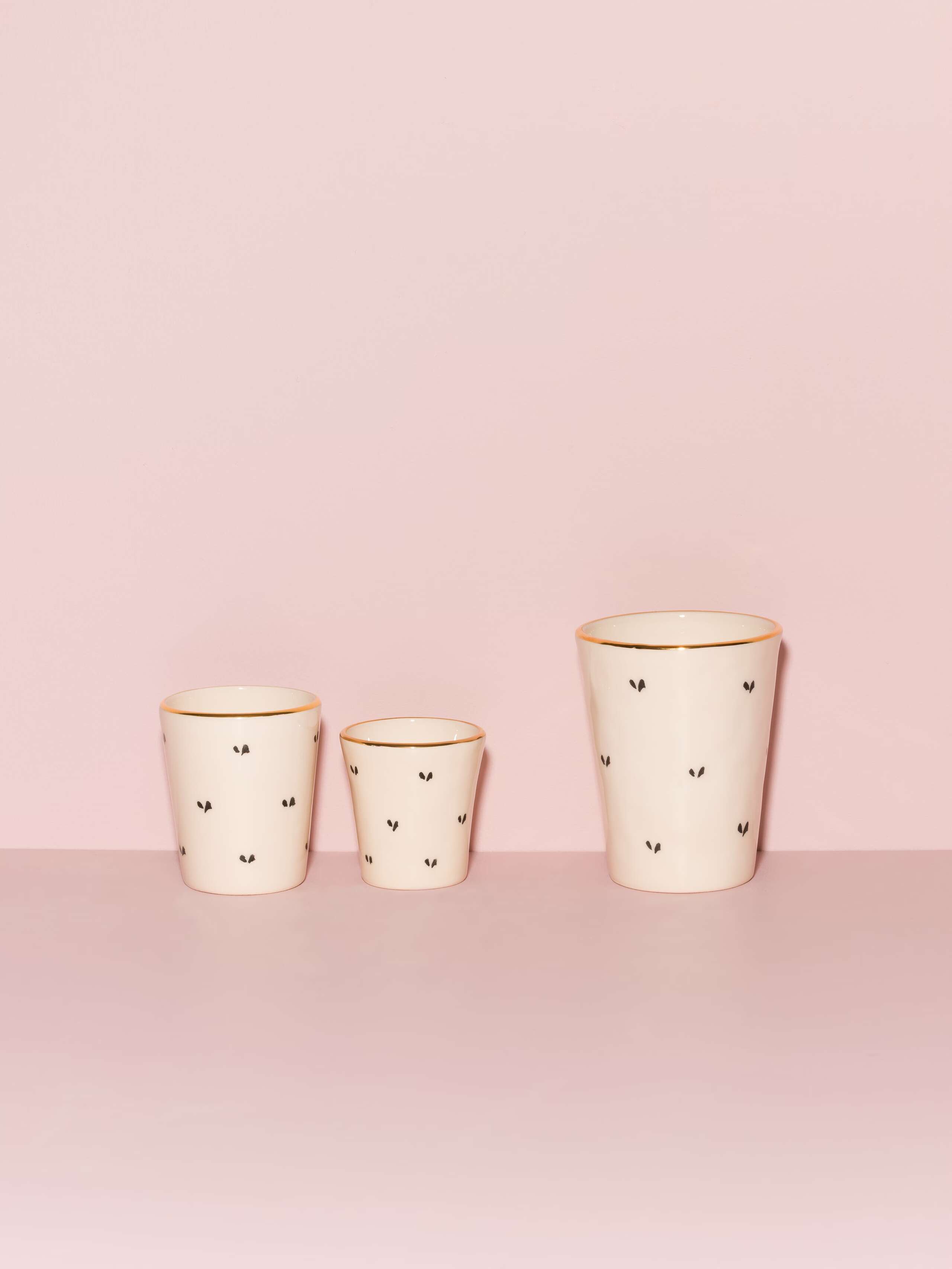 Picture of three ceramic cups featuring a beautiful heart shape pattern
