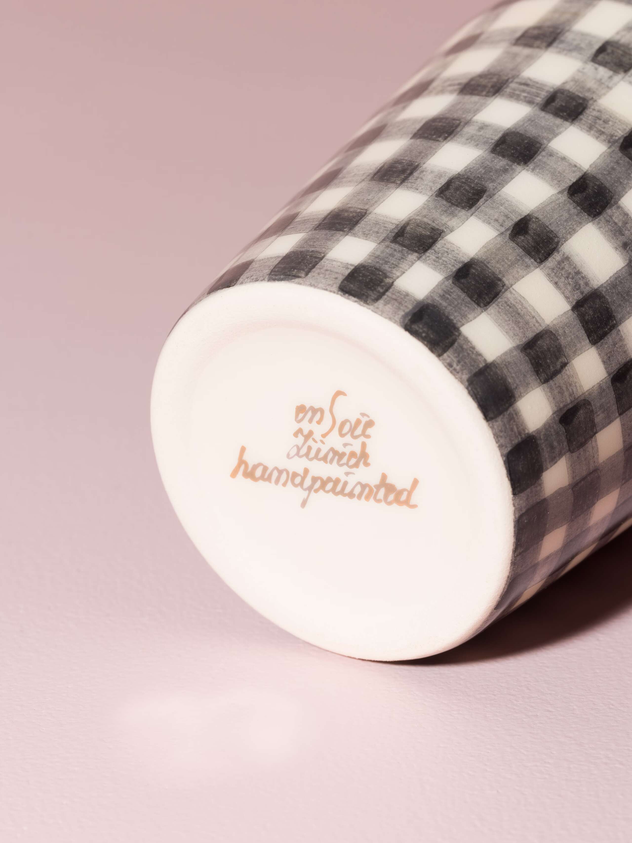 Picture of a detail of a coffee cup featuring the text "enSoie Zurich handpainted"