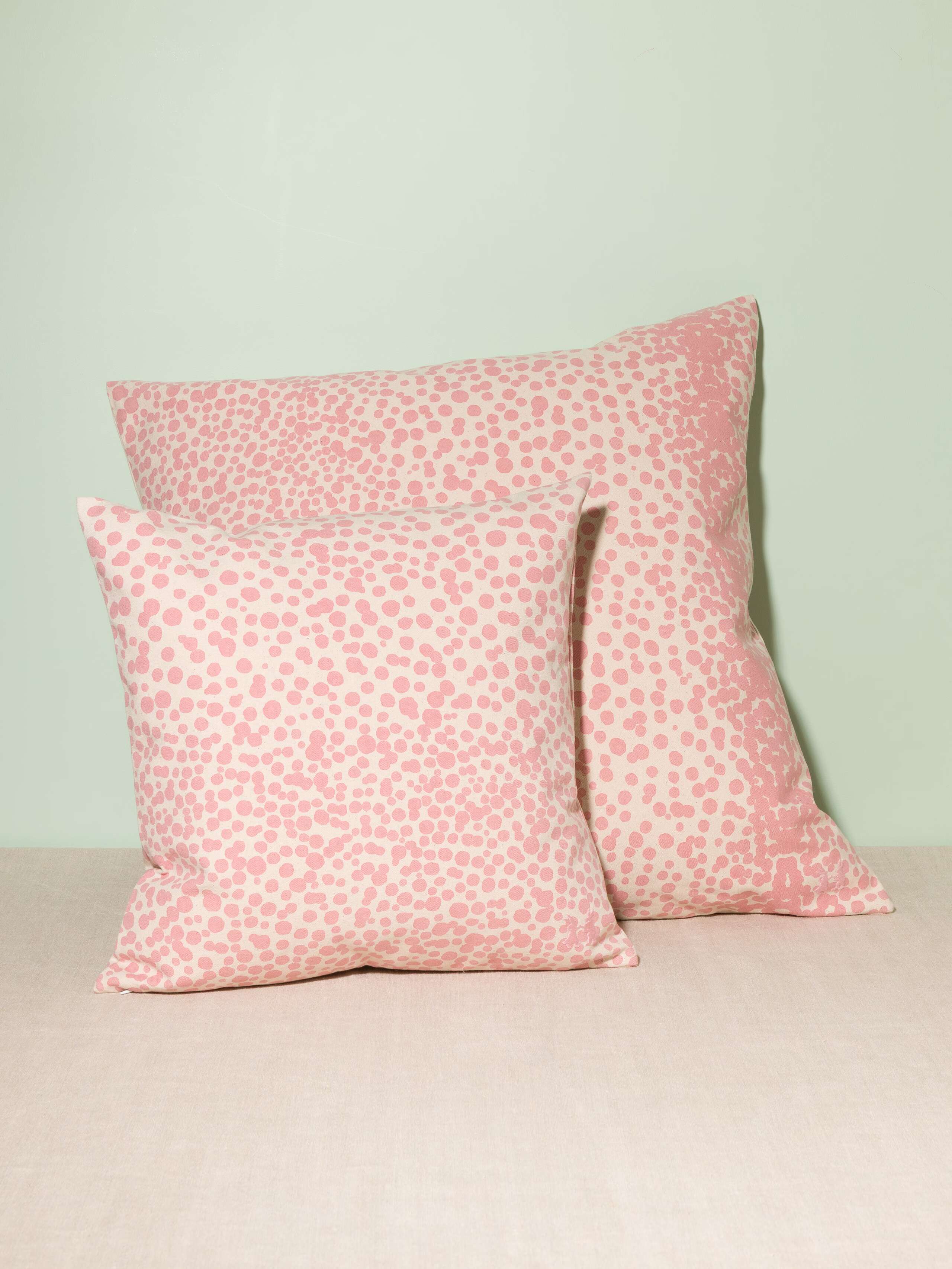 Picture of two pillow covers made of cotton canvas featuring pink dots