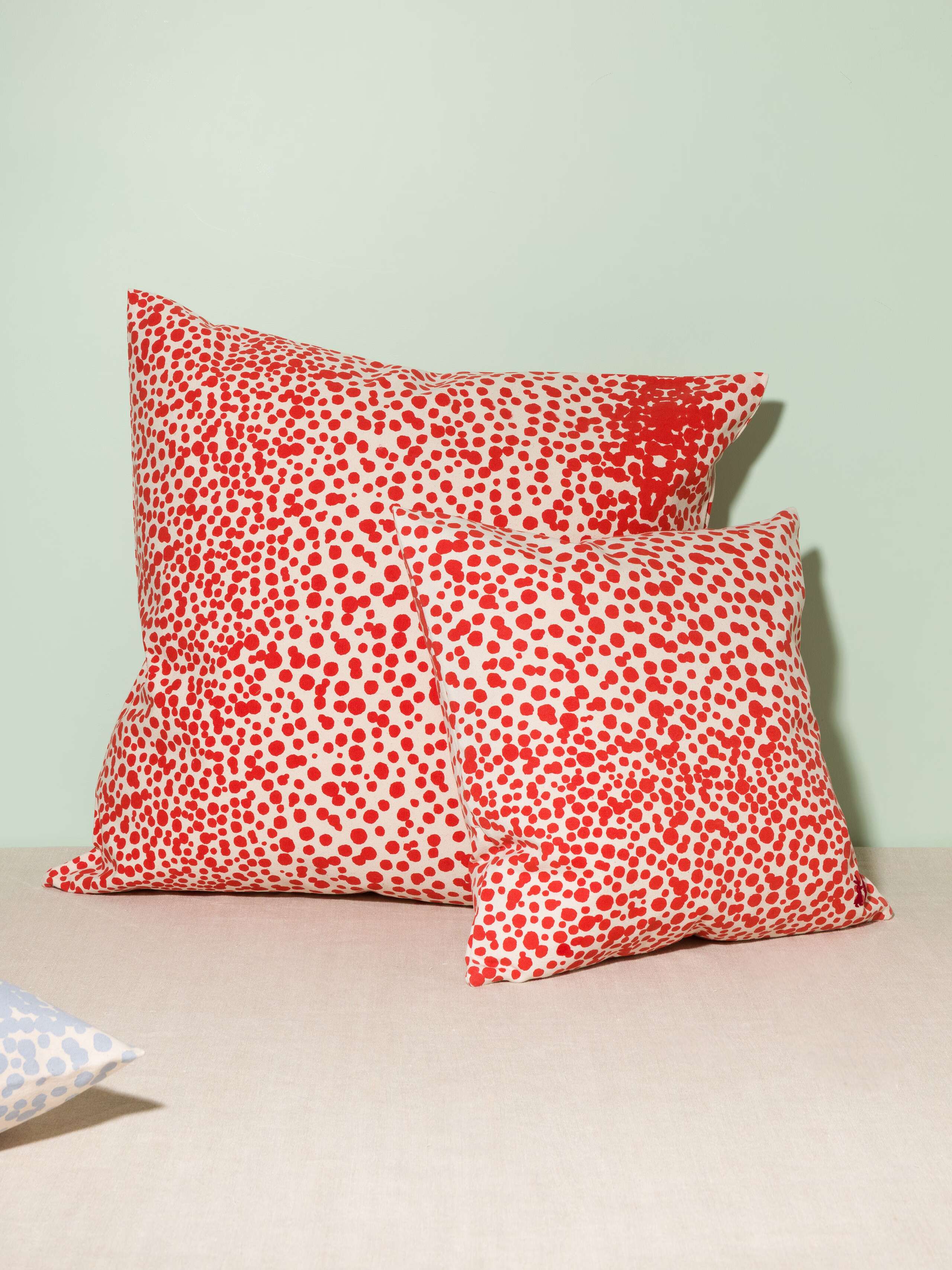 Picture of two pillow covers made of cotton canvas featuring red dots