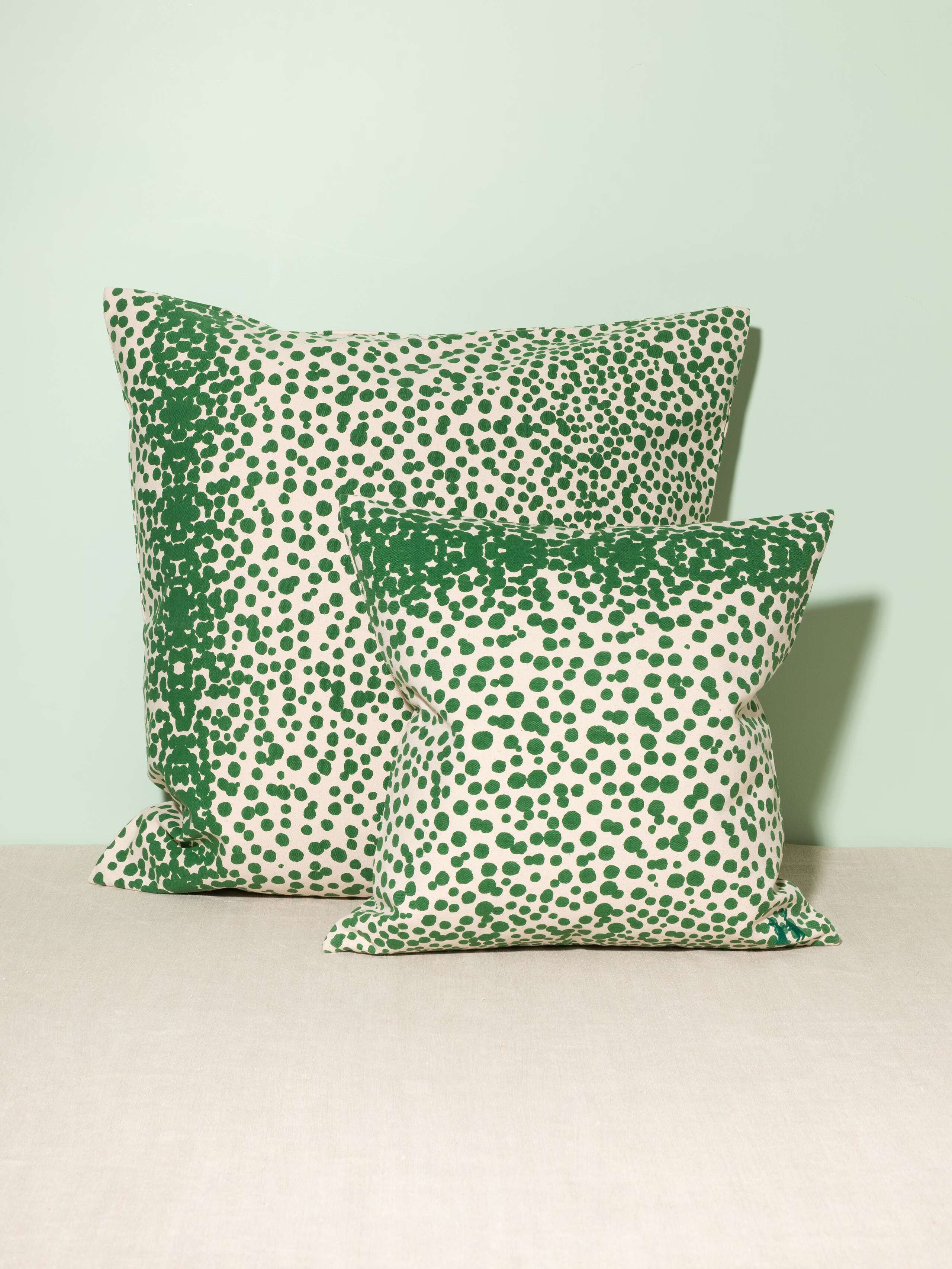 Picture of two pillow covers made of cotton canvas featuring green dots