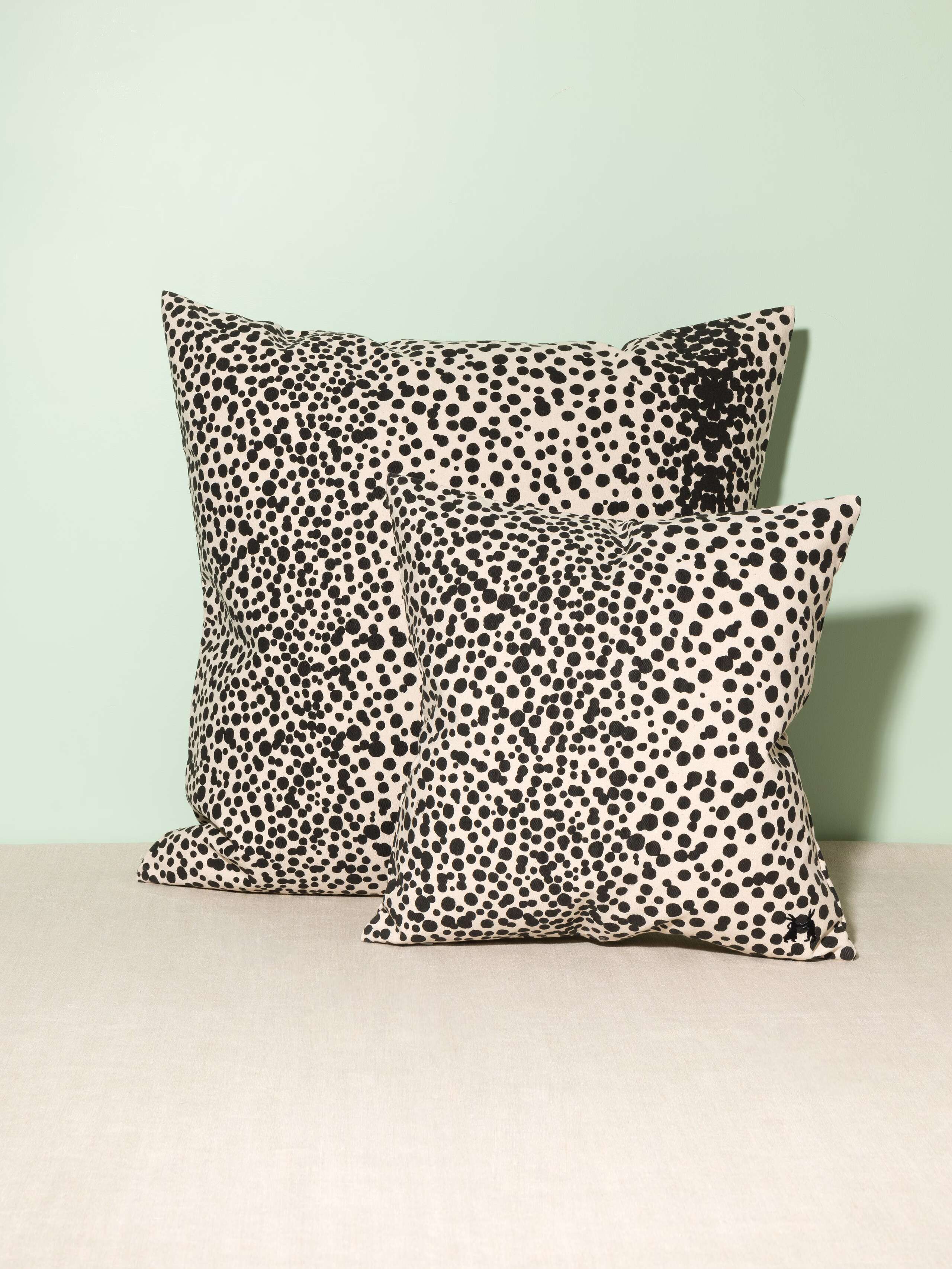 Picture of two pillow covers made from cotton canvas featuring black dots