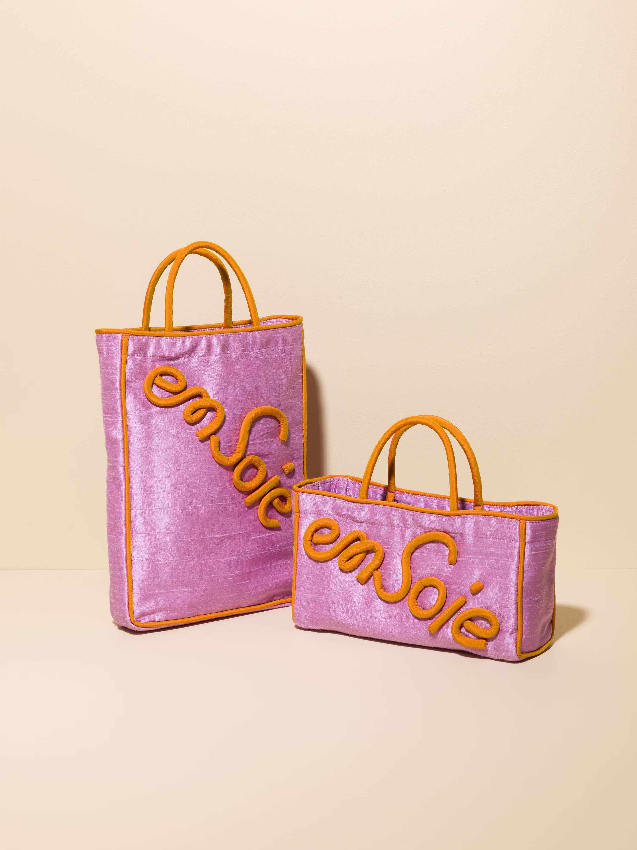 Picture of two lavender silk bags with orange details 
