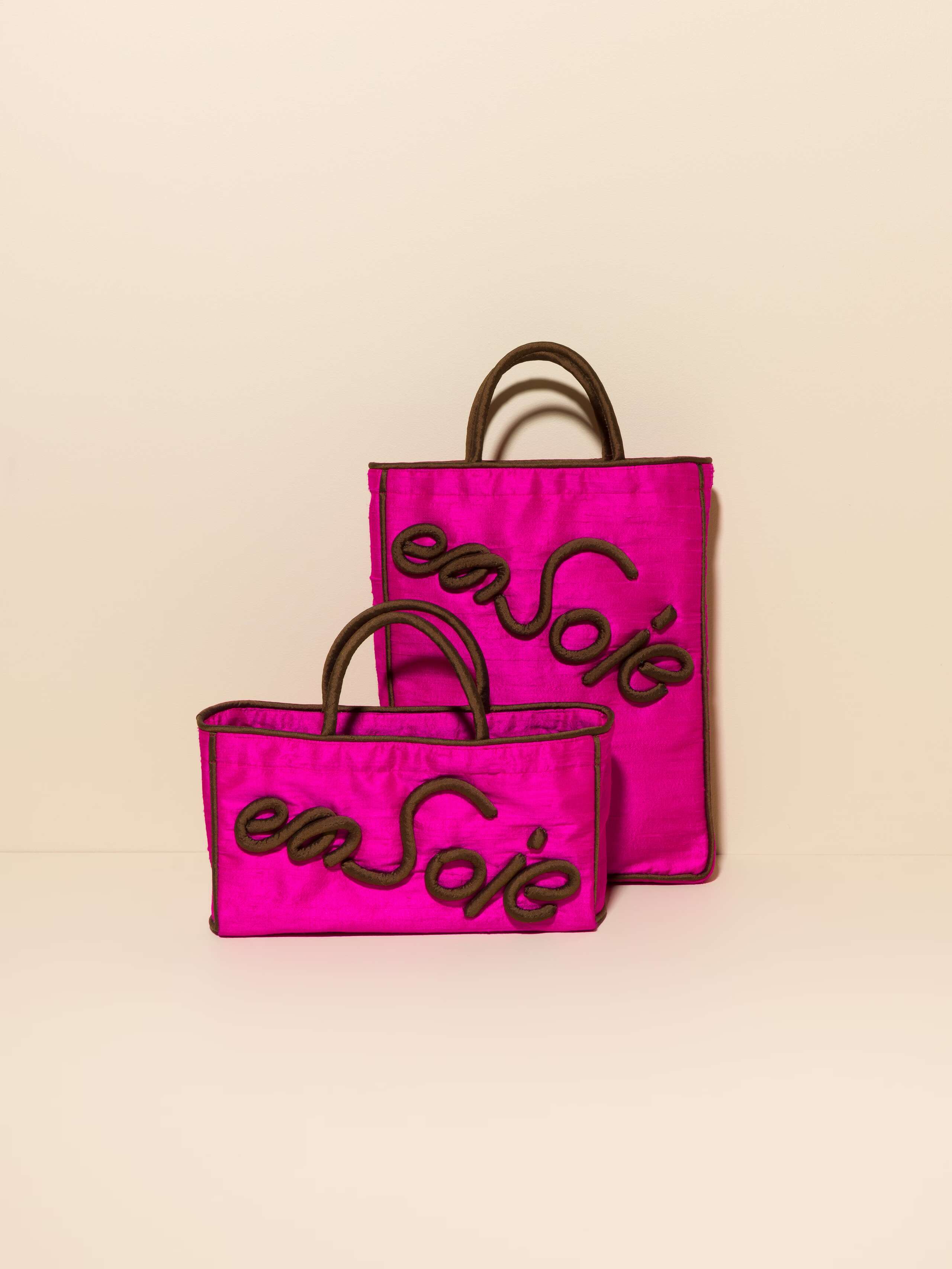 Picture of two pink silk bags with brown details 