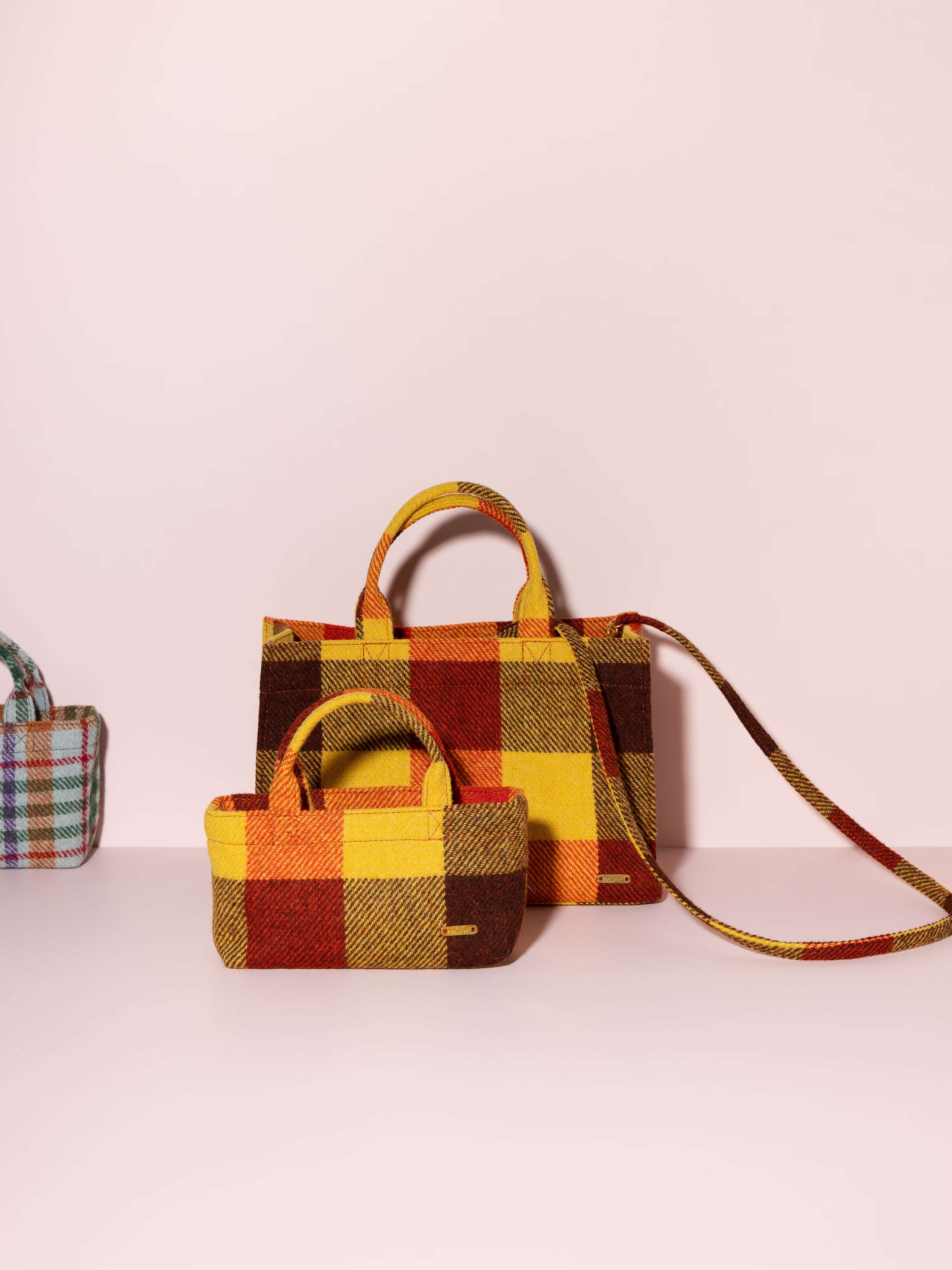 Picture of two handbags made of colourful harris tweed wool fabric 