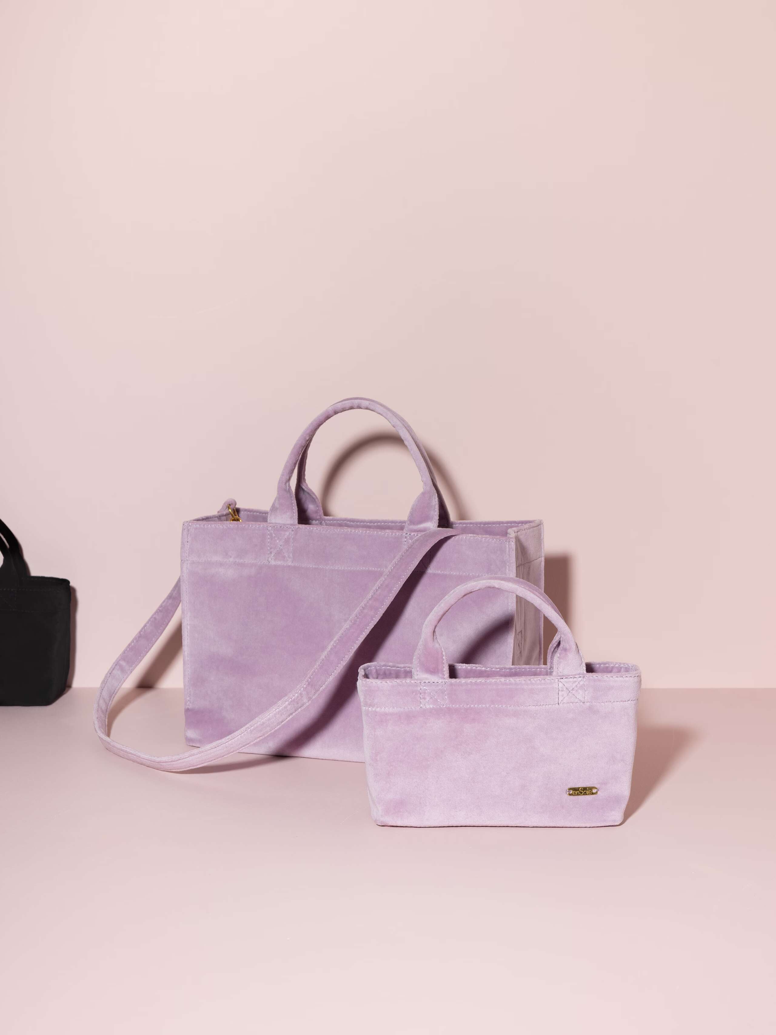 Picture of two handbags made of lavender coloured velvet