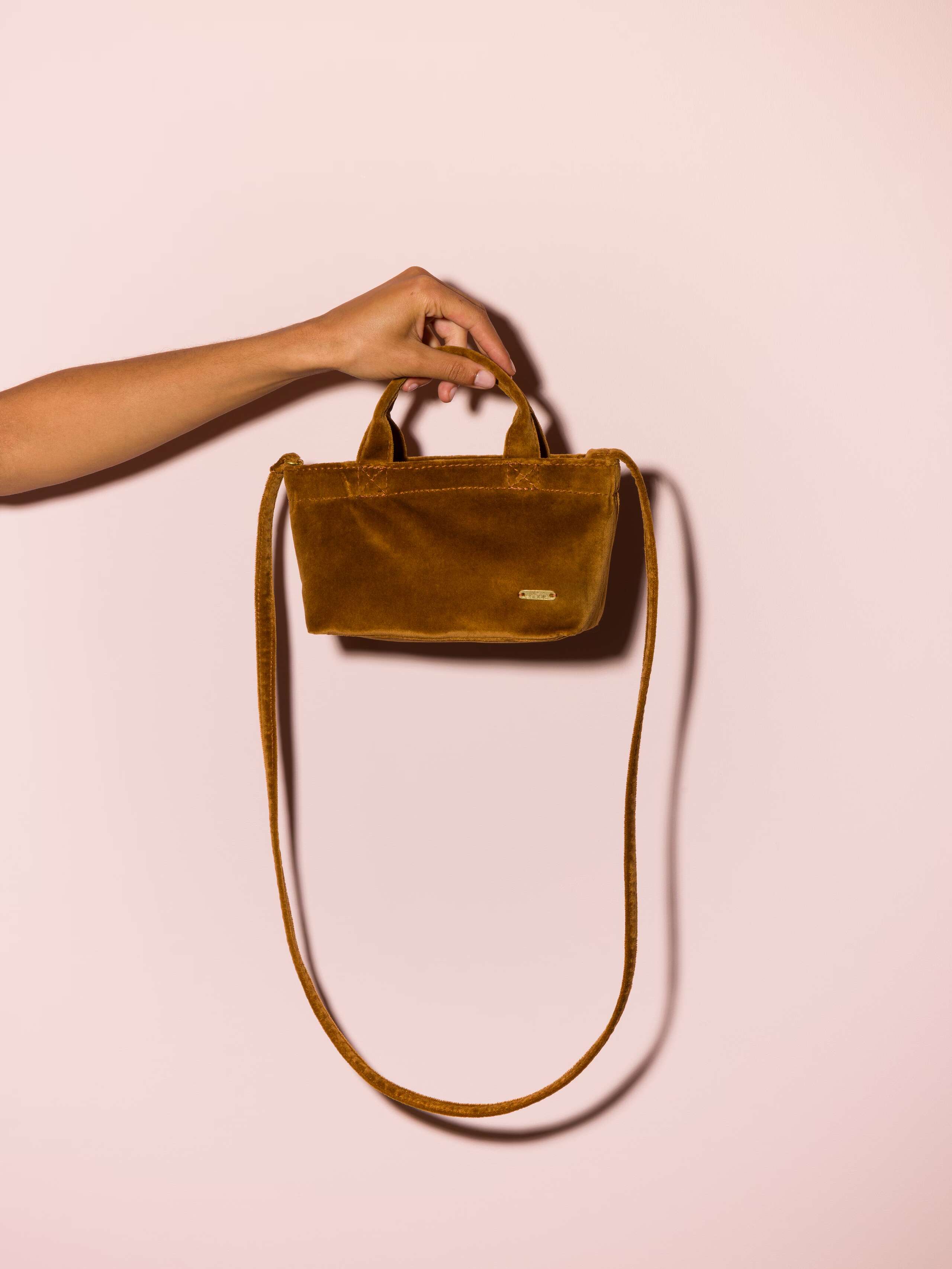 Picture of a micro hand bag made of cognac velvet fabric 