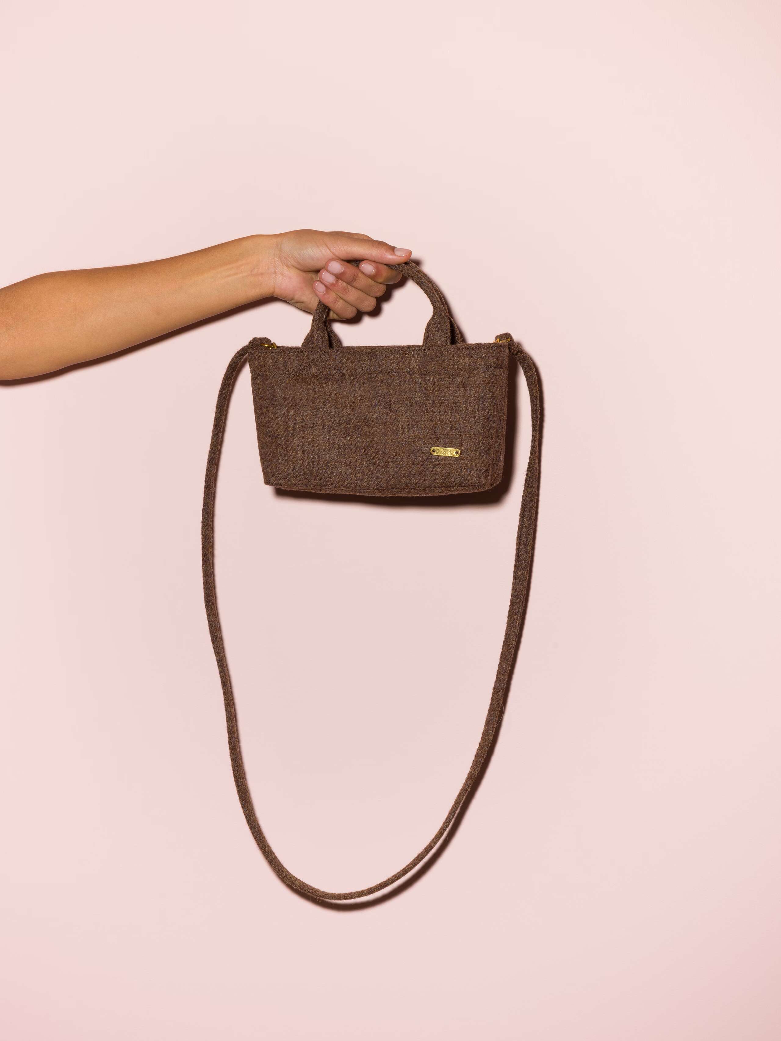 Picture of a micro hand bag made of brown Harris Tweed fabric