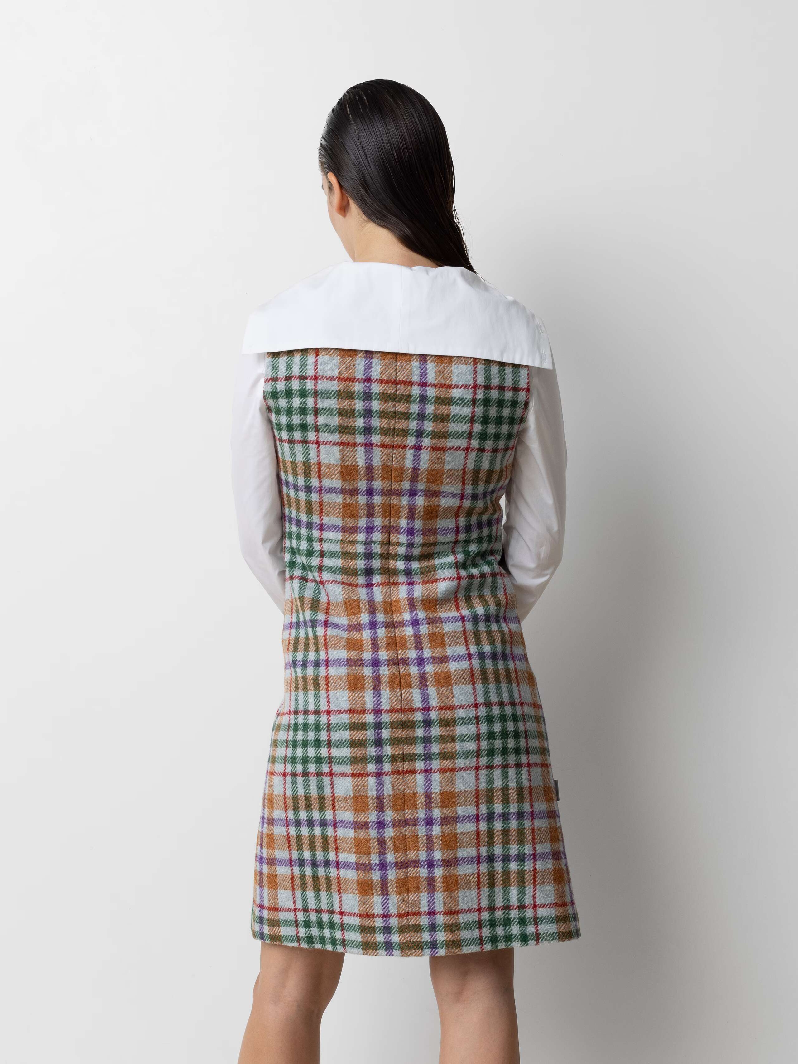 Picture of a female model wearing a wool dress made from Harris Tweed