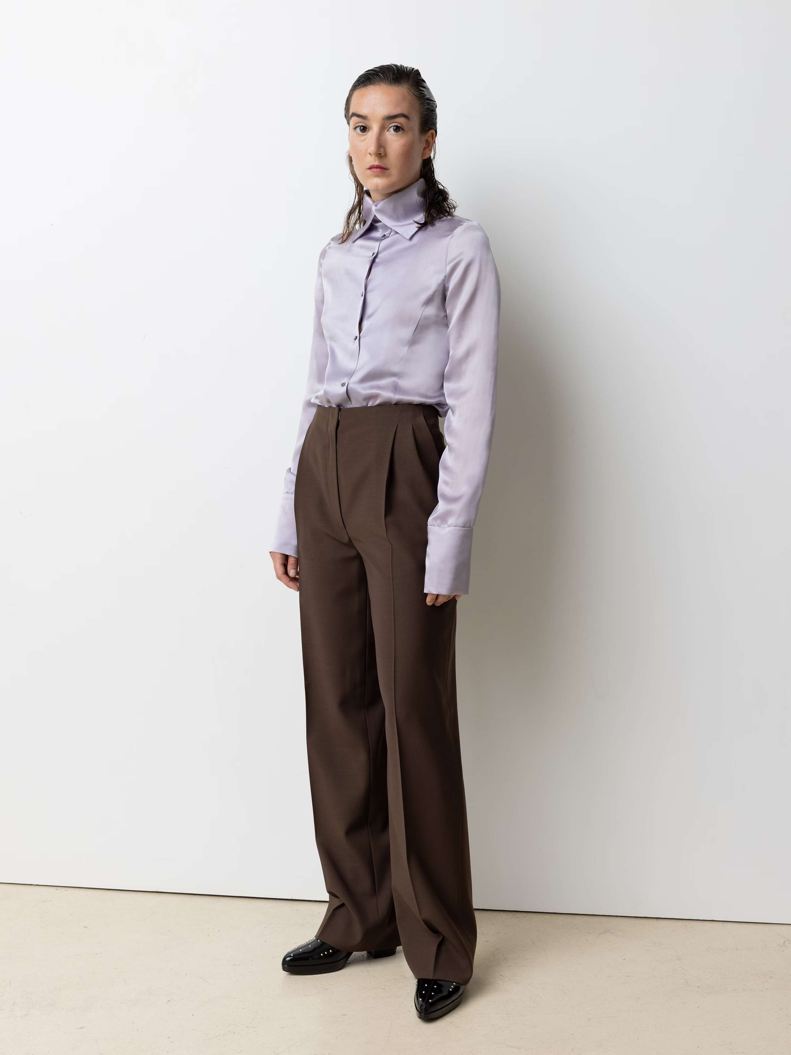 Picture of a female model wearing a lilac coloured satin silk blouse
