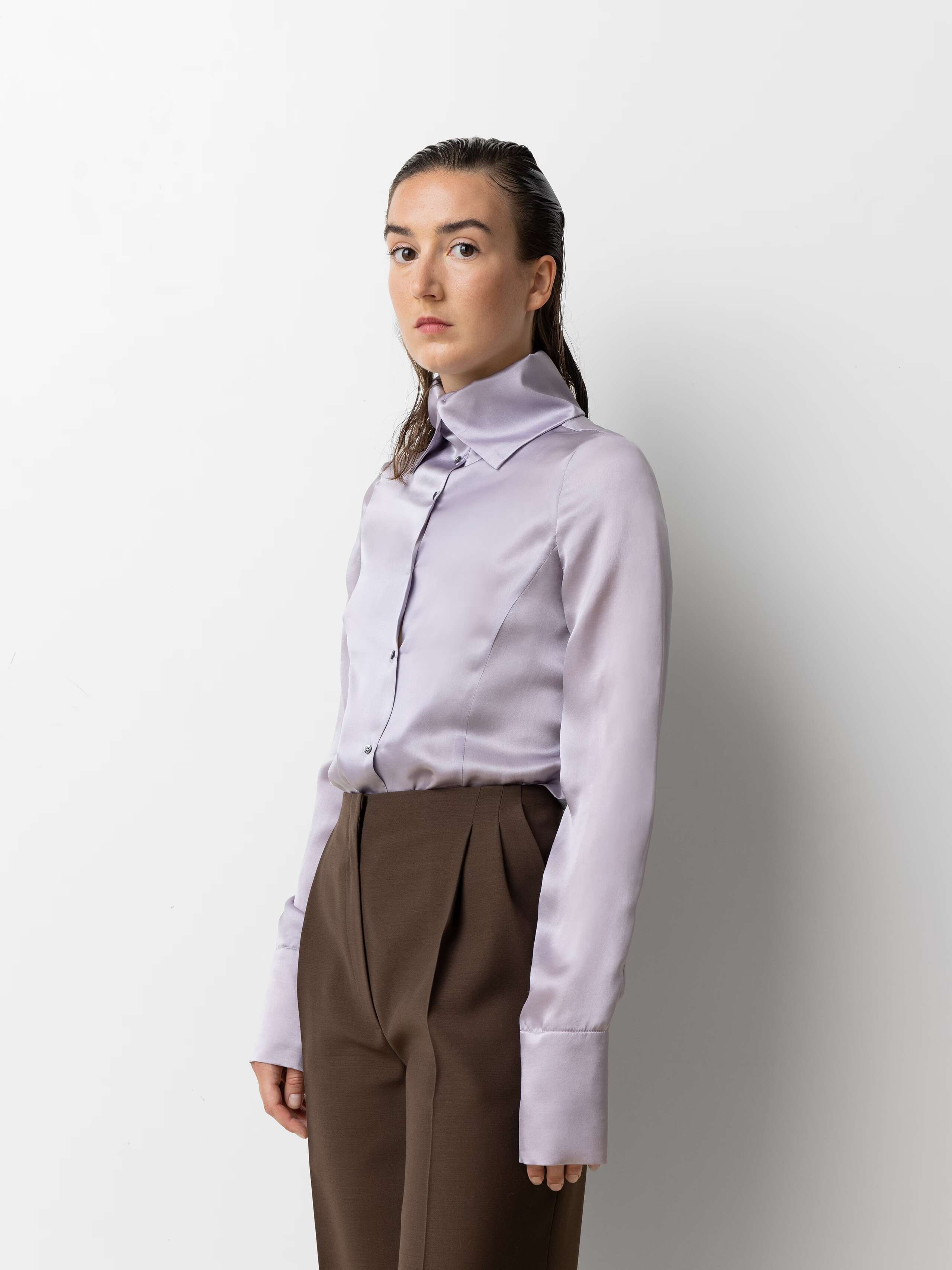 Picture of a female model wearing a lilac coloured satin silk blouse