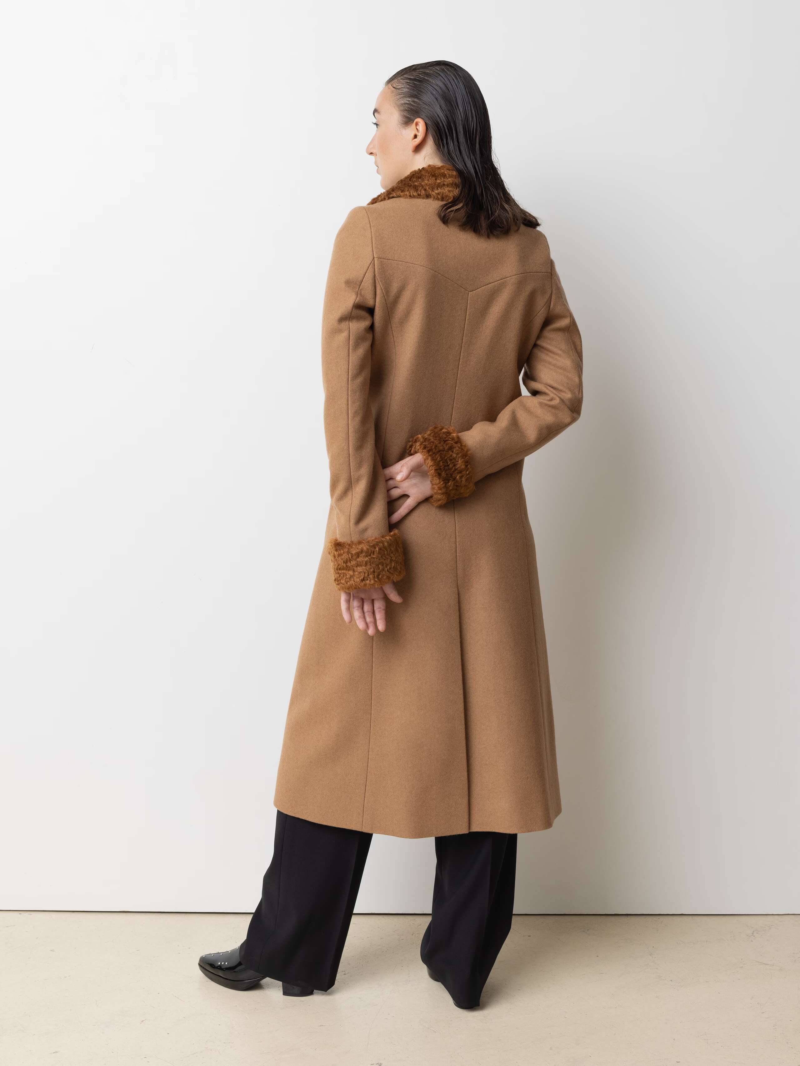 Picture of a female model wearing a beige winter coat