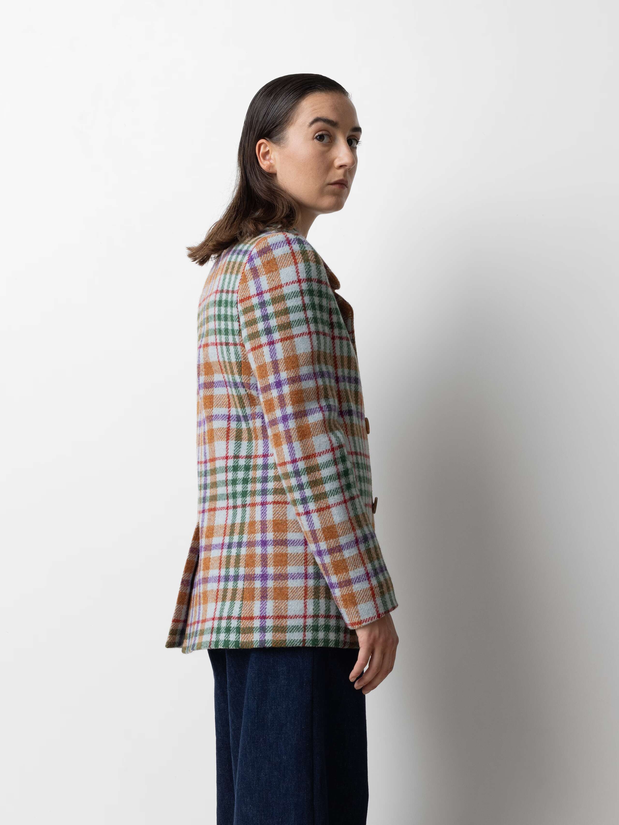 Picture of a female model wearing a colourful wool blazer 