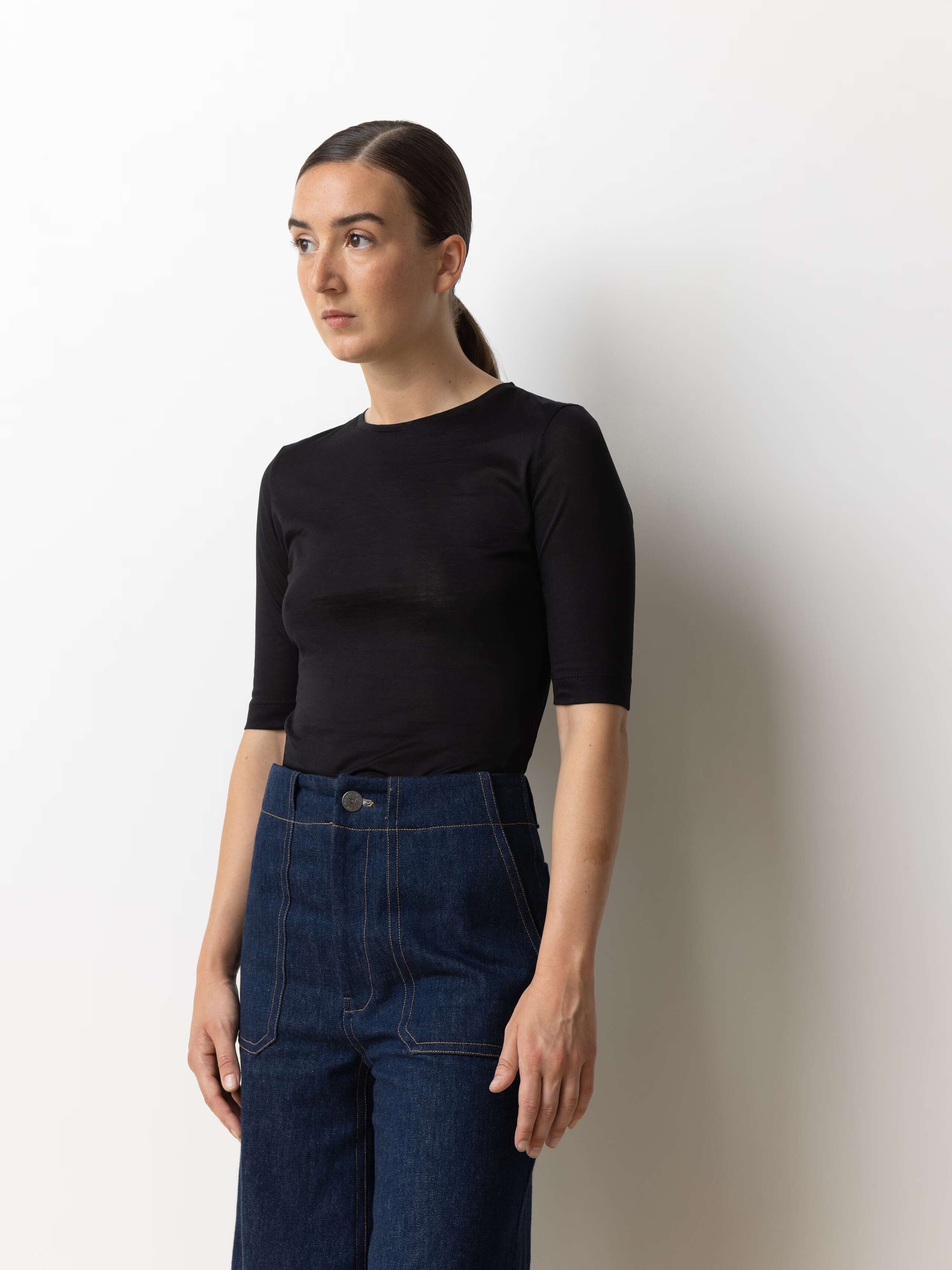 Picture of a female model wearing a black light cotton t-shirt 