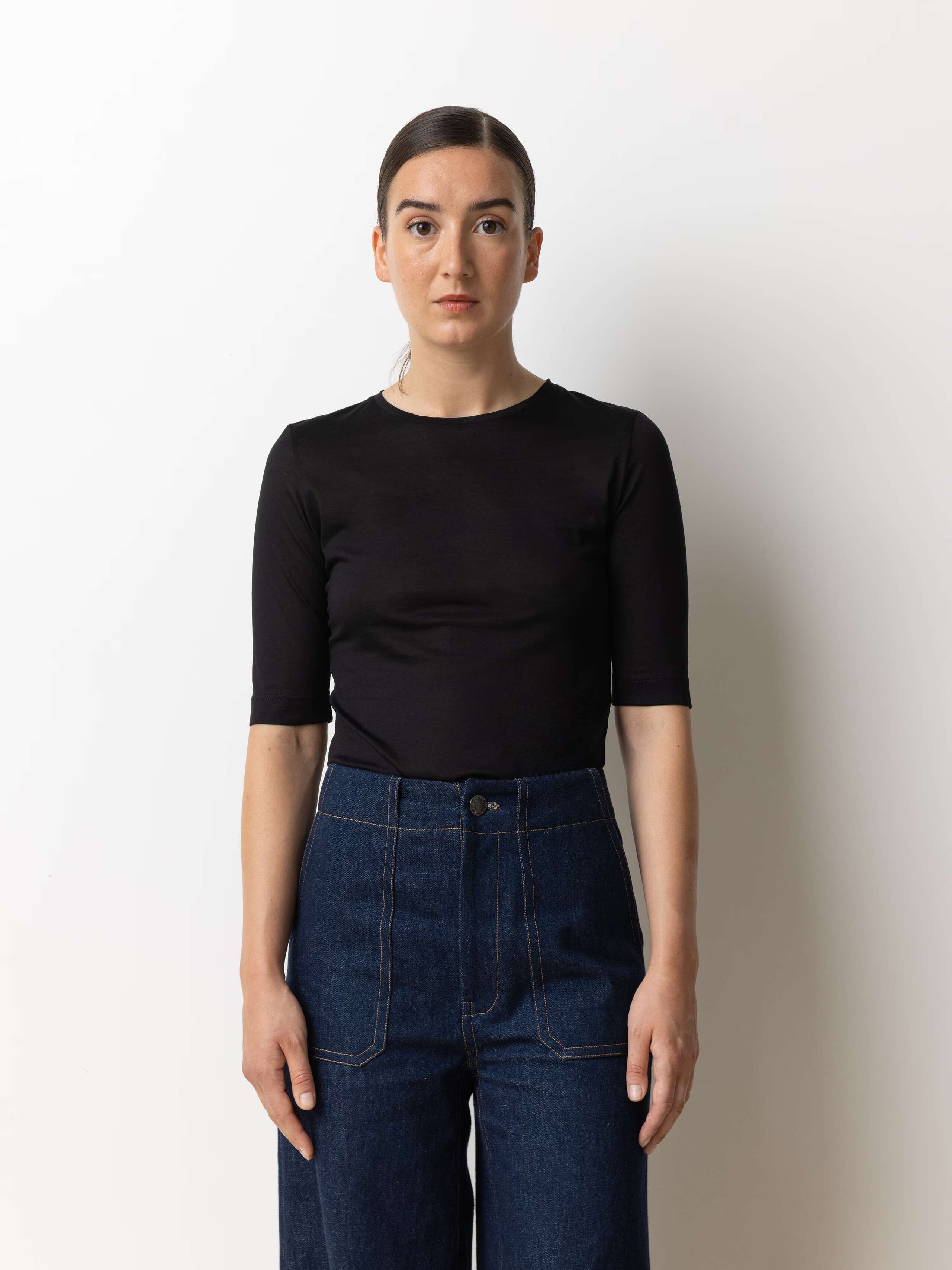 picture of a female model wearing a tight form fitting black cotton jersey t-shirt