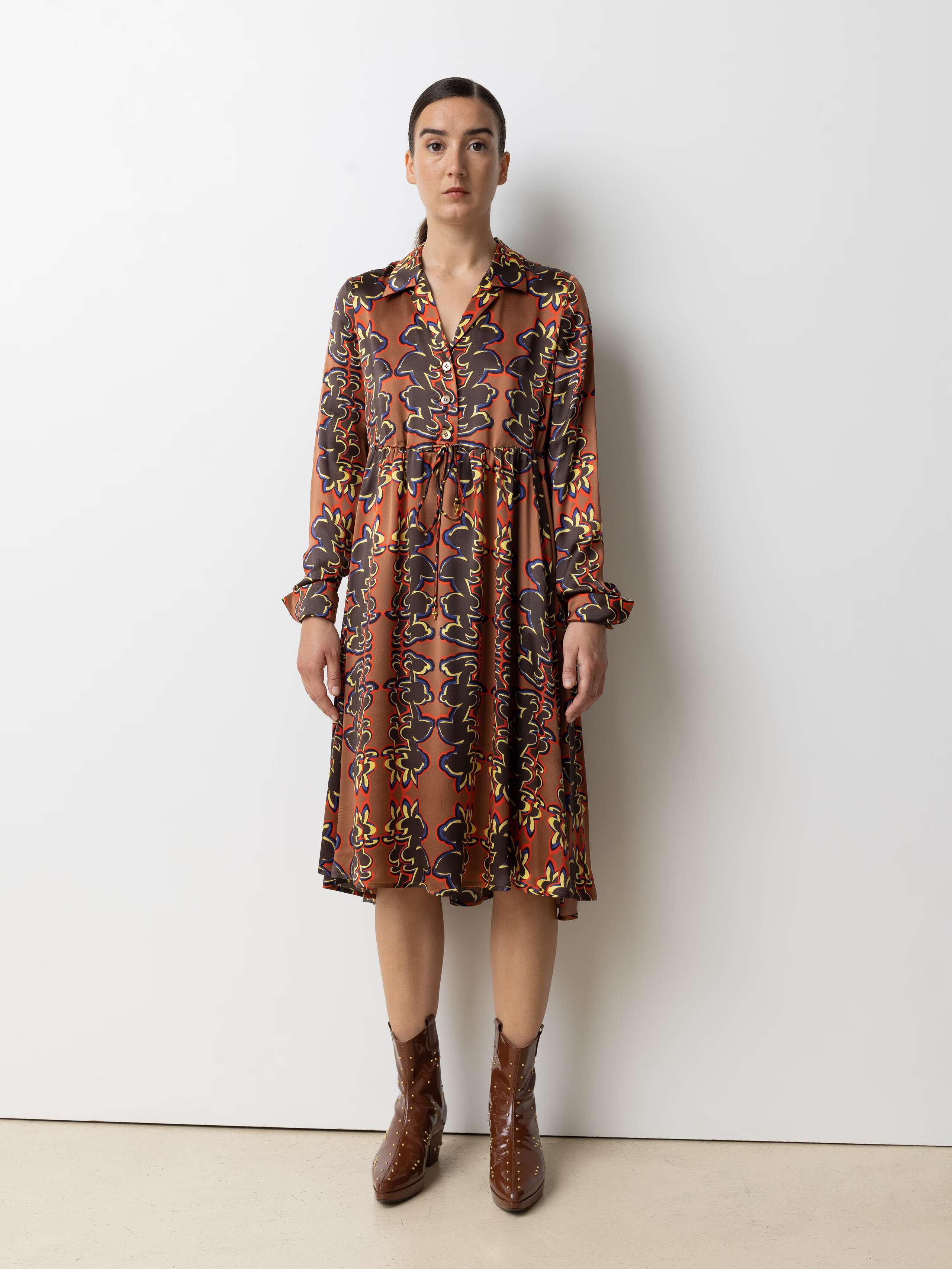 Picture of a female model wearing a beautiful silk dress featuring a nice rabbit print in red, yellow and bleu shades