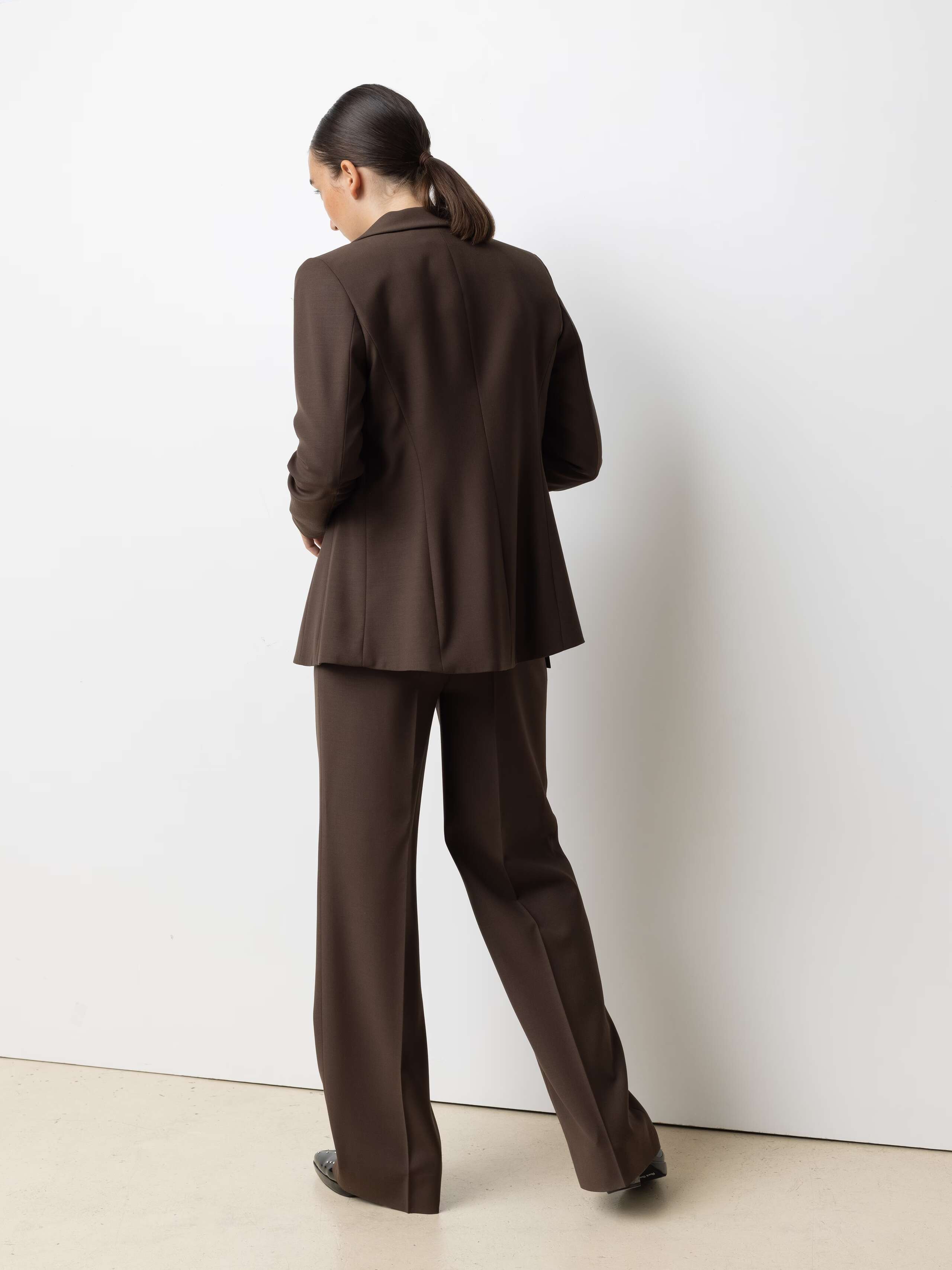 Picture of a model wearing a lavender coloured silk blouse in combination with brown cool wool pant