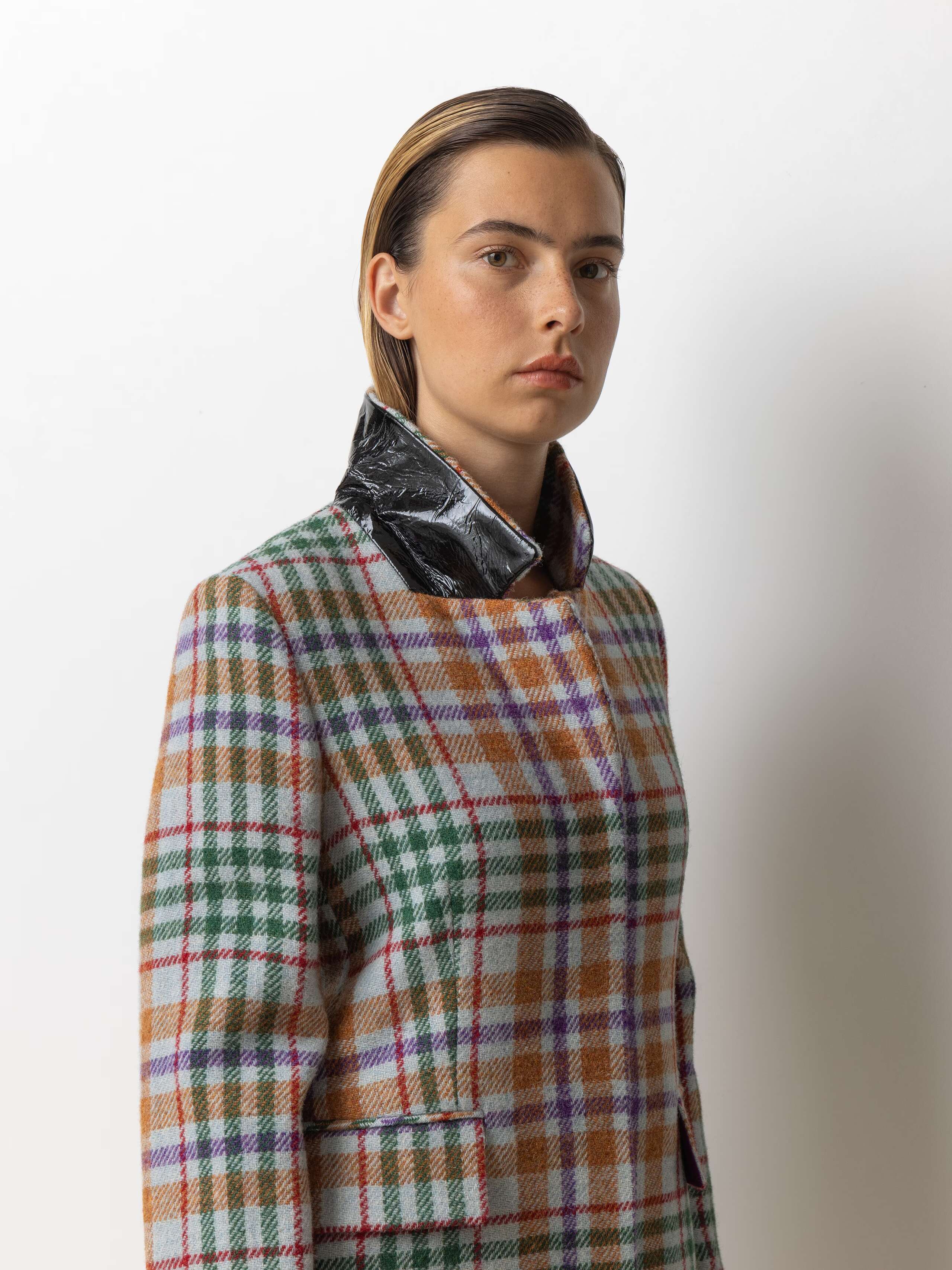 Picture of a female model wearing a classic wool coat made from Harris Tweed