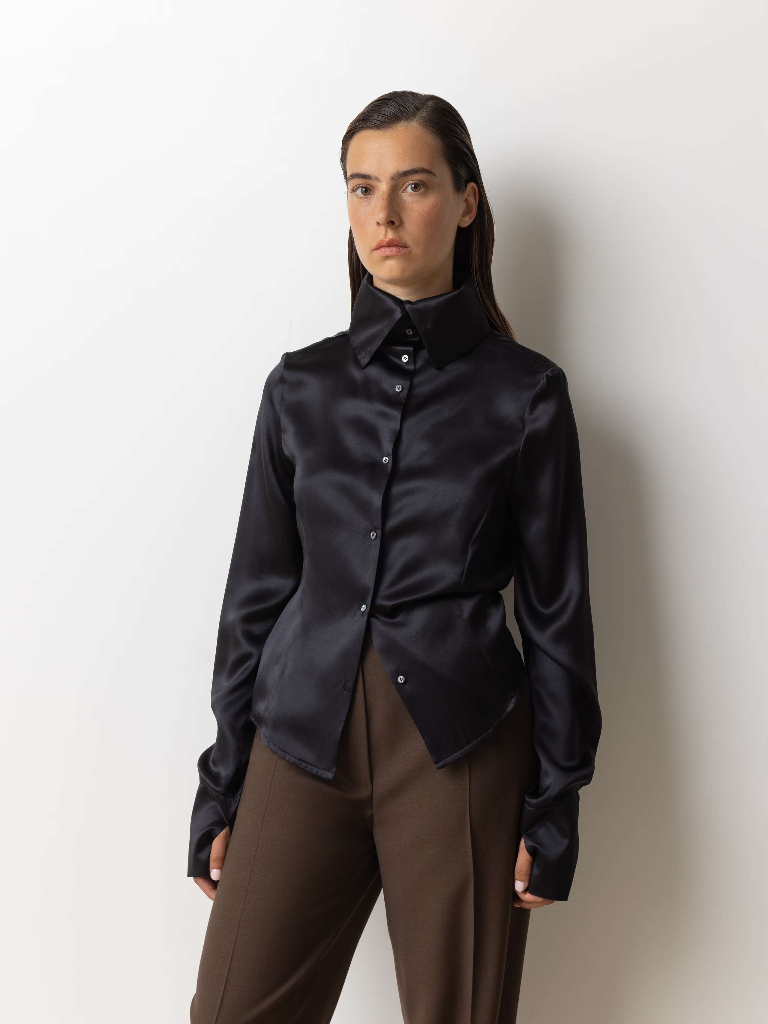 Picture of a female model wearing a black silk blouse