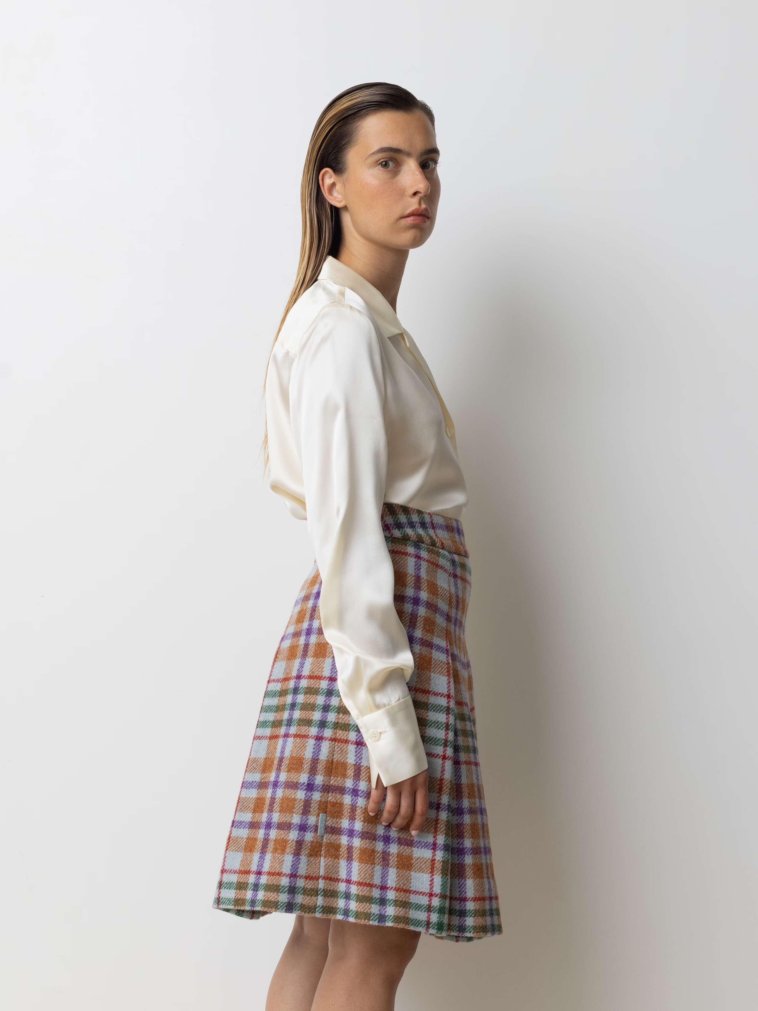 Picture of a model wearing a medium long wool skirt in bright colours