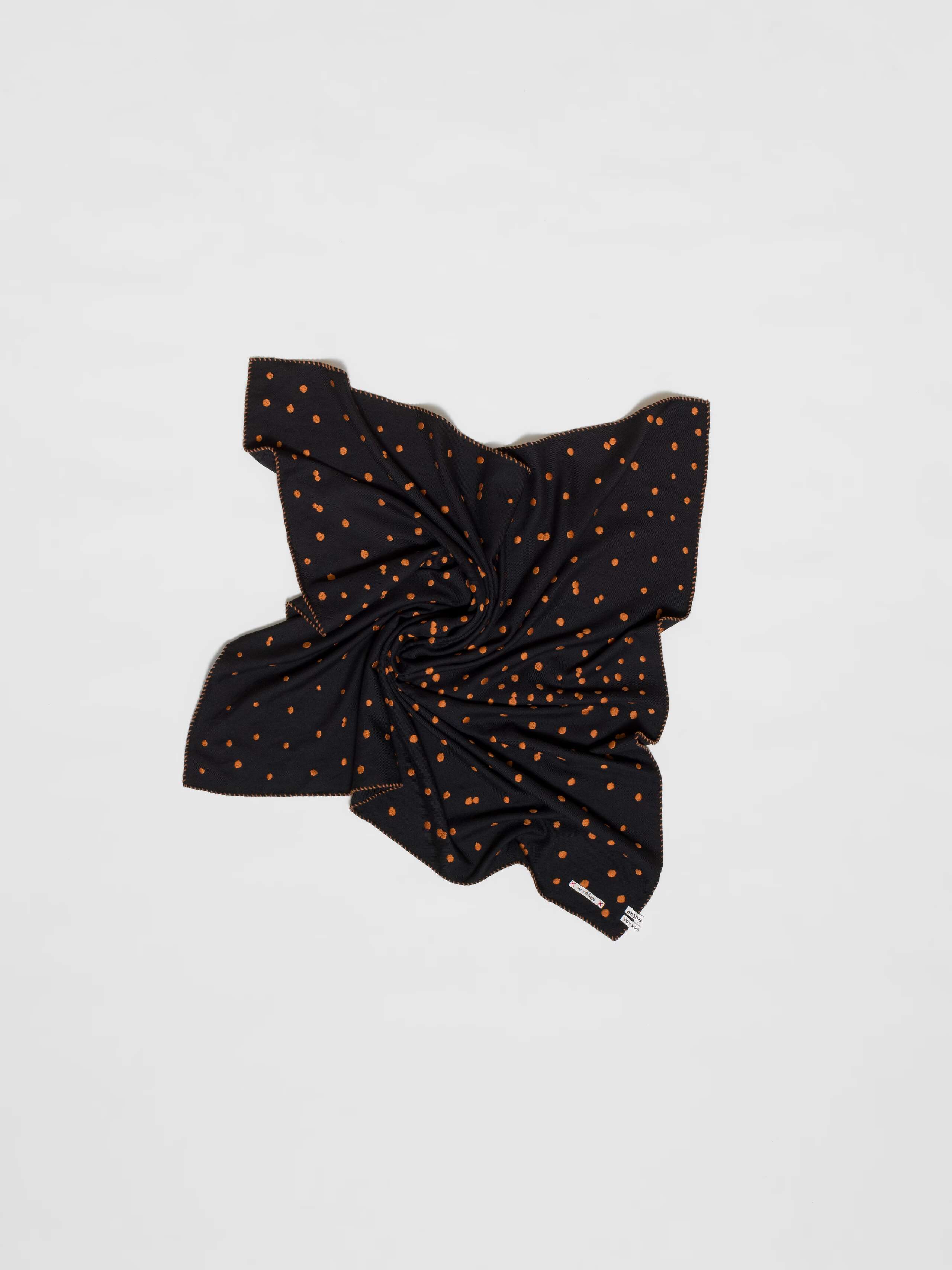 Picture of a wool foulard in black featuring brown hand embroidered dots