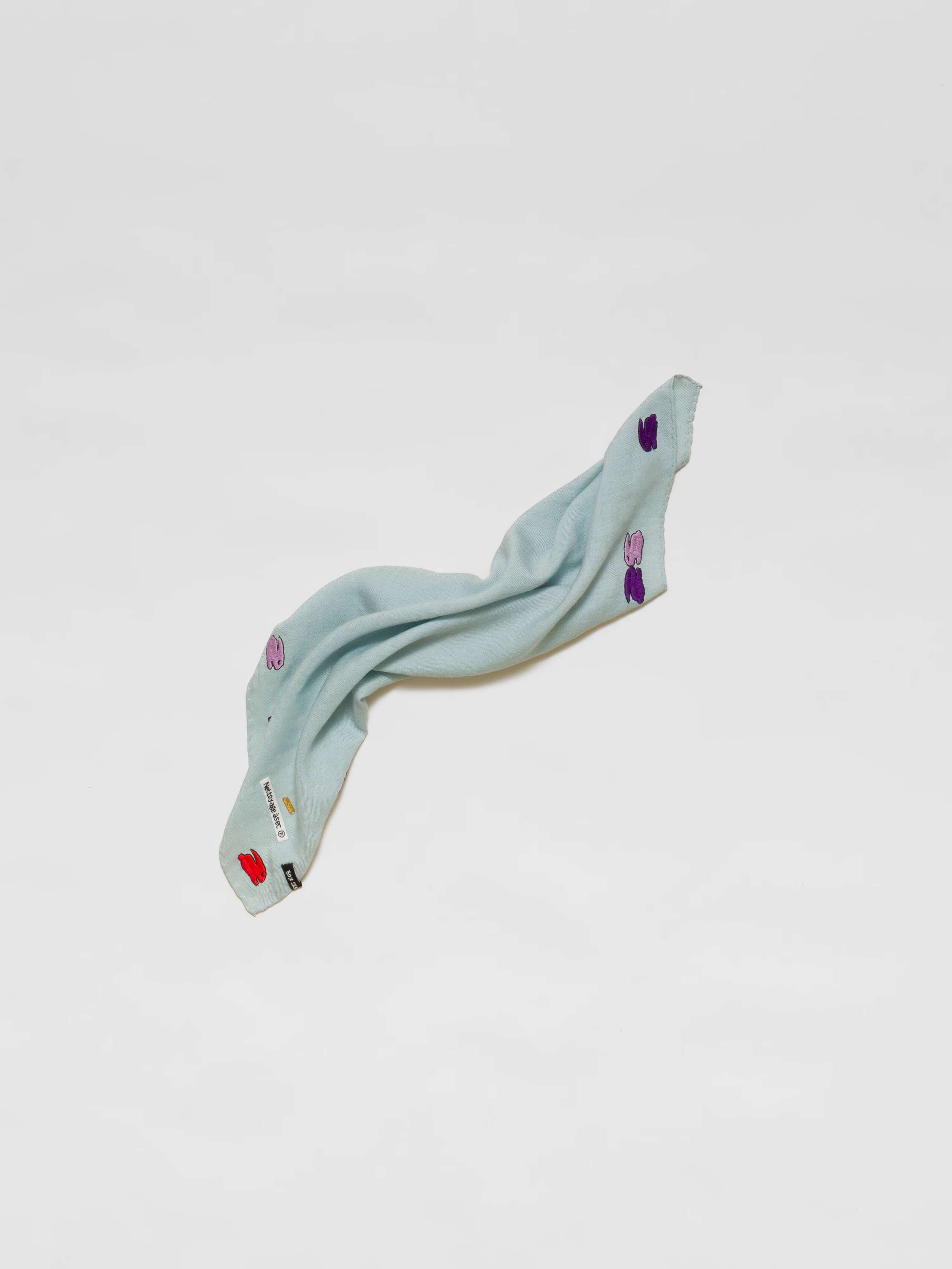 Picture of a light blue wool silk scarf featuring a cute rabbit embroidery