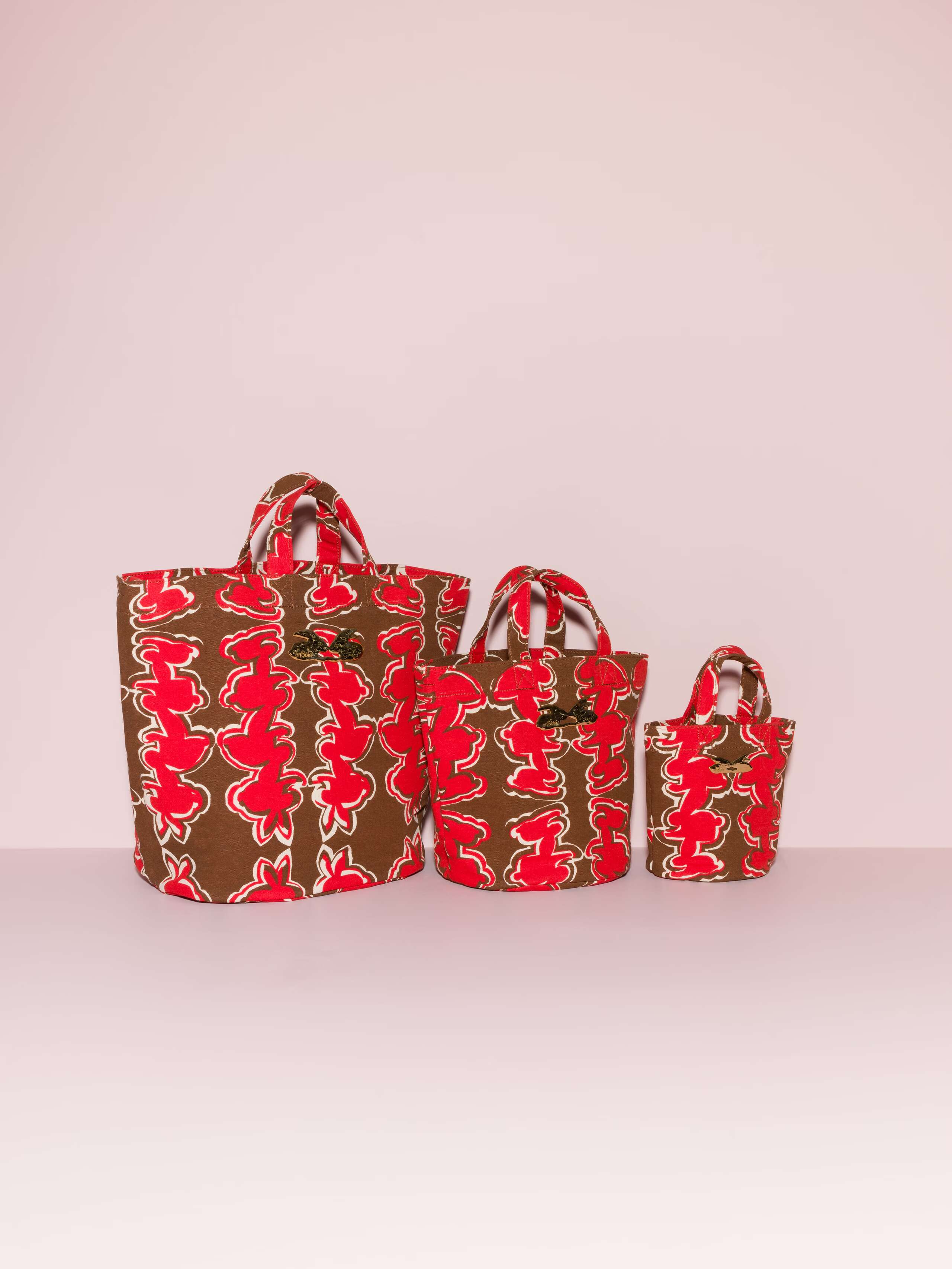 Picture of three beautiful bags featuring a red rabbit print on a brown ground
