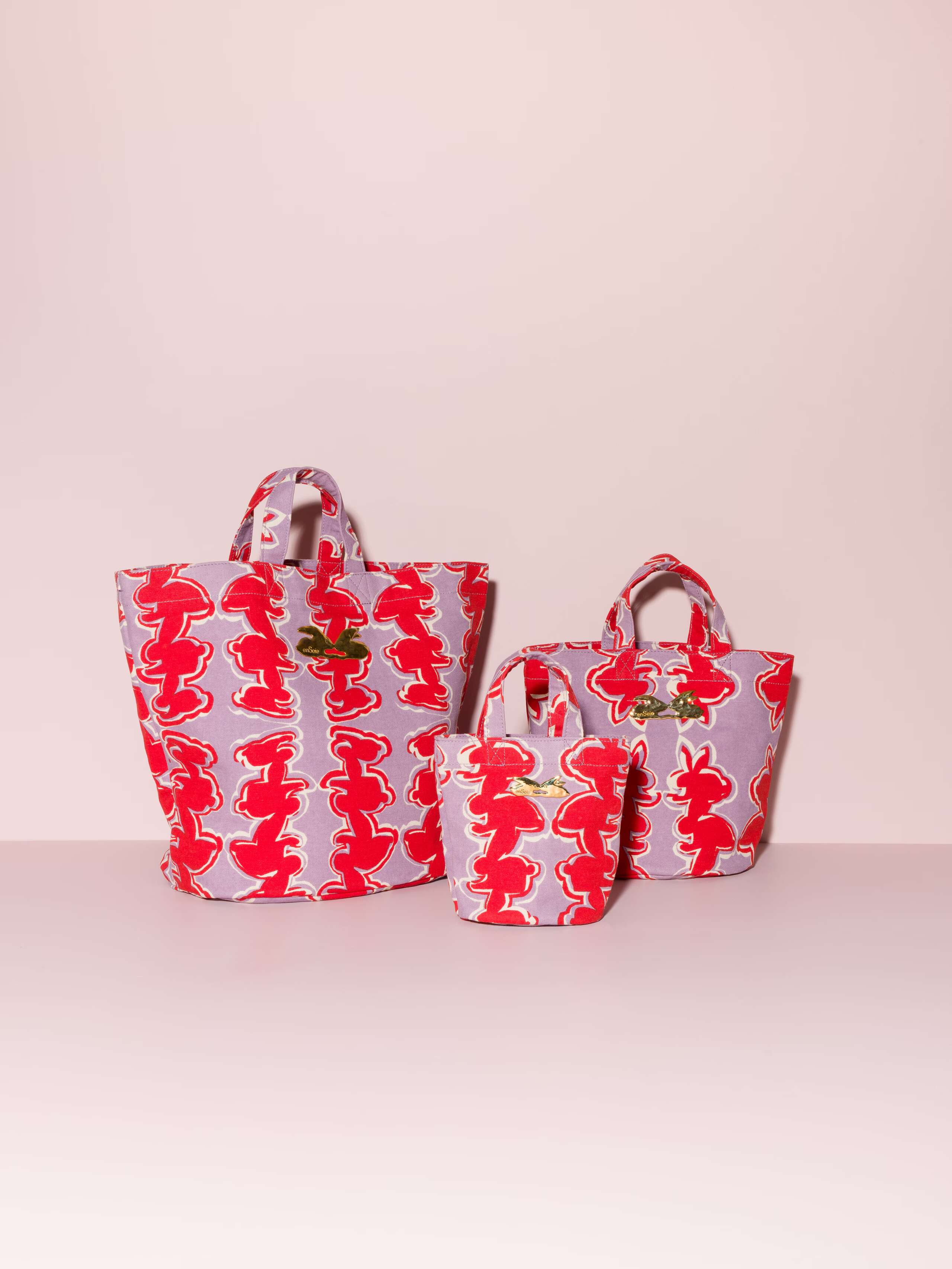 Picture of three beautiful bags featuring a red rabbit print on a lavender ground