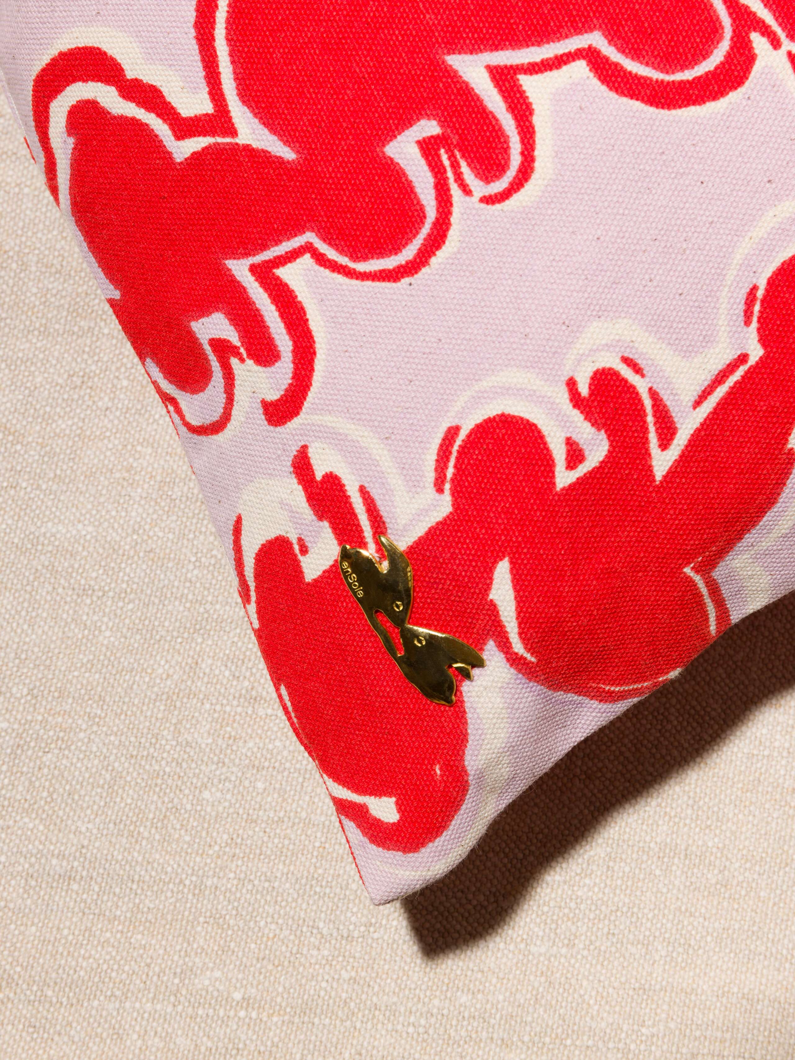 Picture of a brass detail of a cotton canvas pillow cover in a beautiful lavender 
