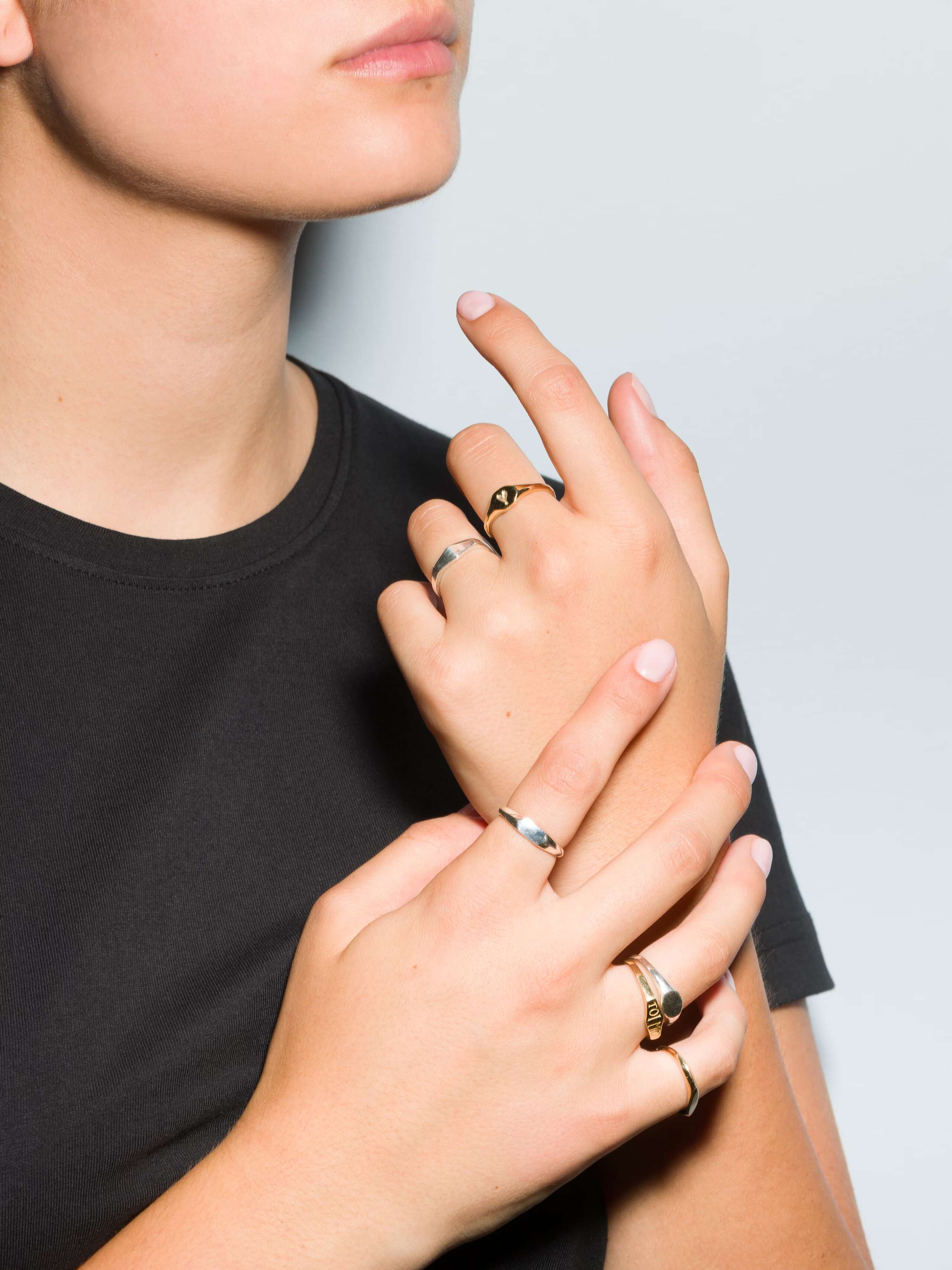 Group of Small 9 karat gold and silver signet ring called Ida on a set of hands