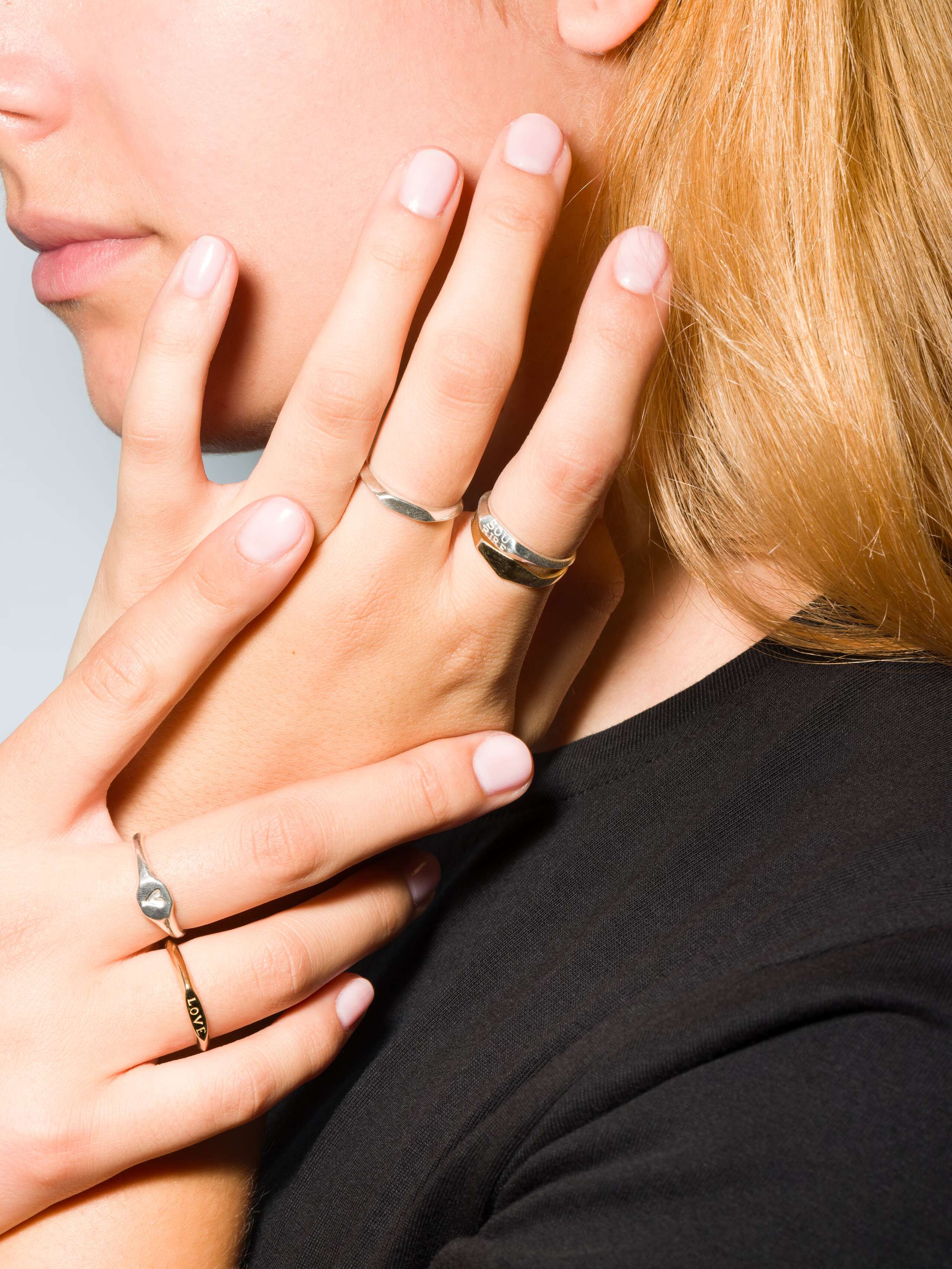 Group of Small 9 karat gold and silver signet ring called Ida on a set of hands