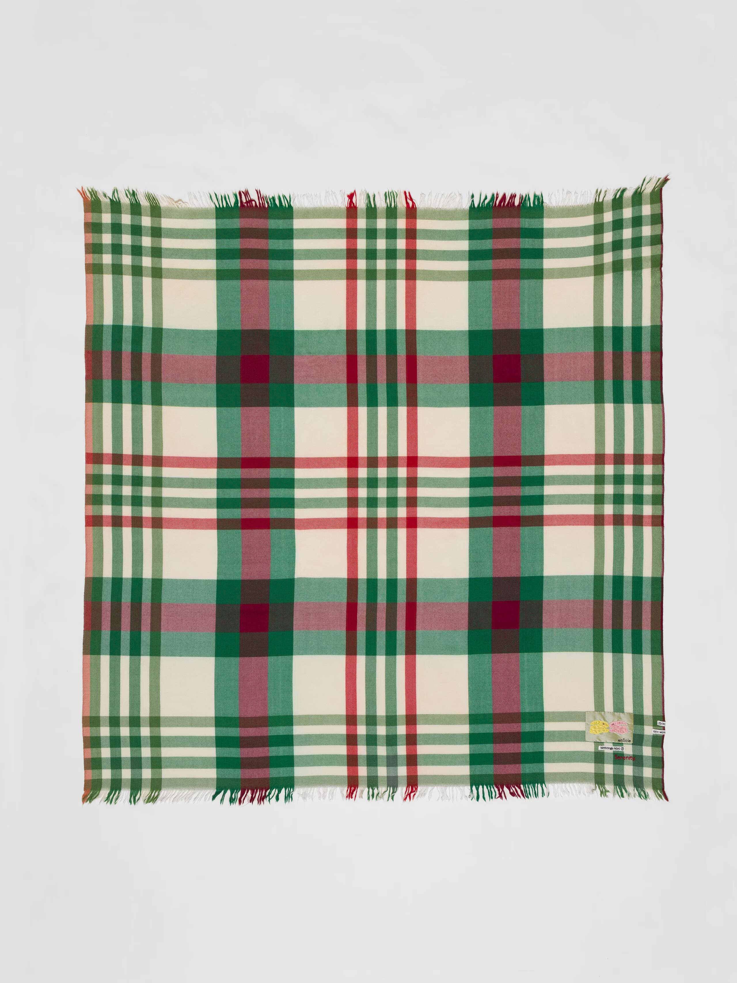 Picture of a colourful wool scarf in beige, green and red shades